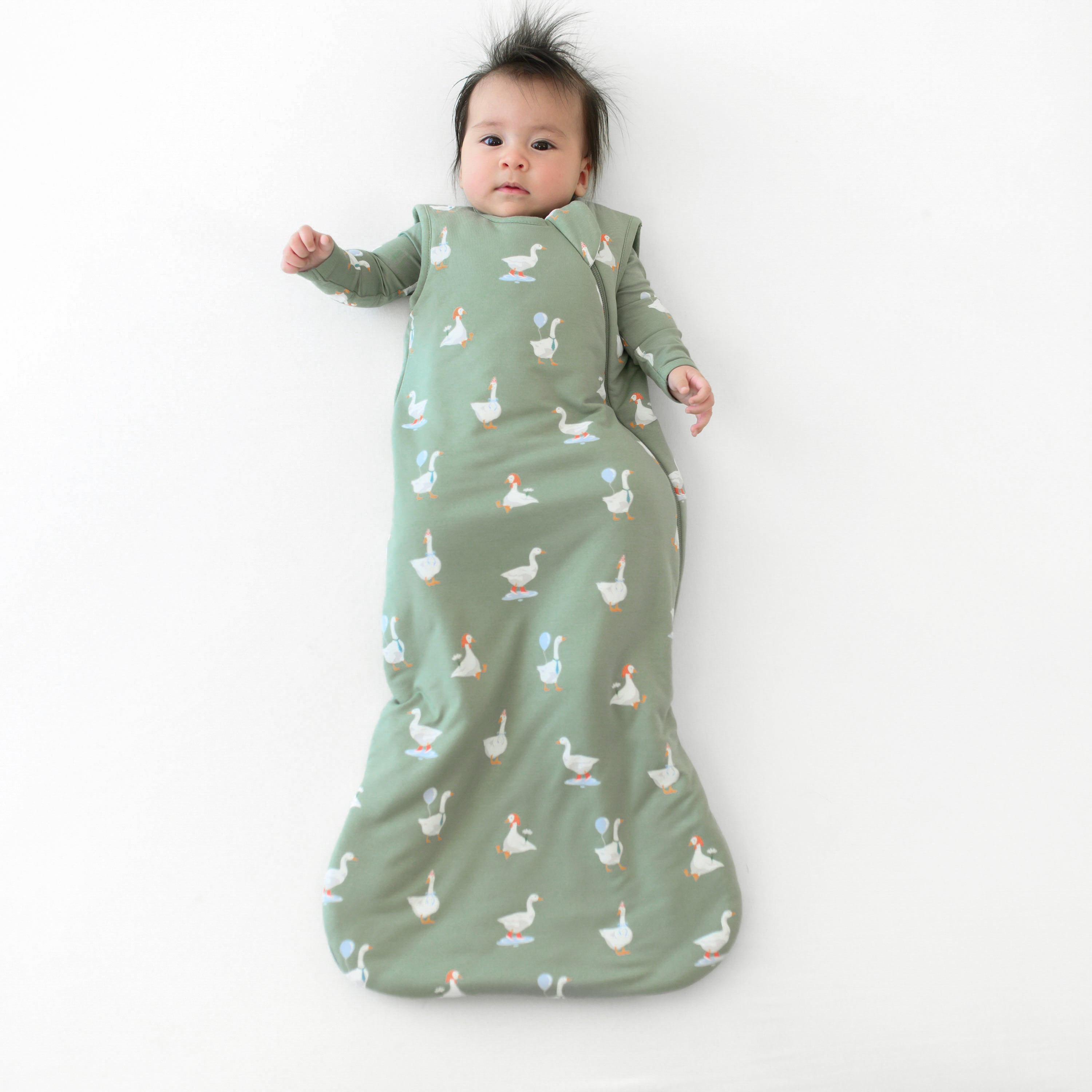 Infant wearing Sleep Bag in Silly Goose 1.0 with matching long sleeve romper