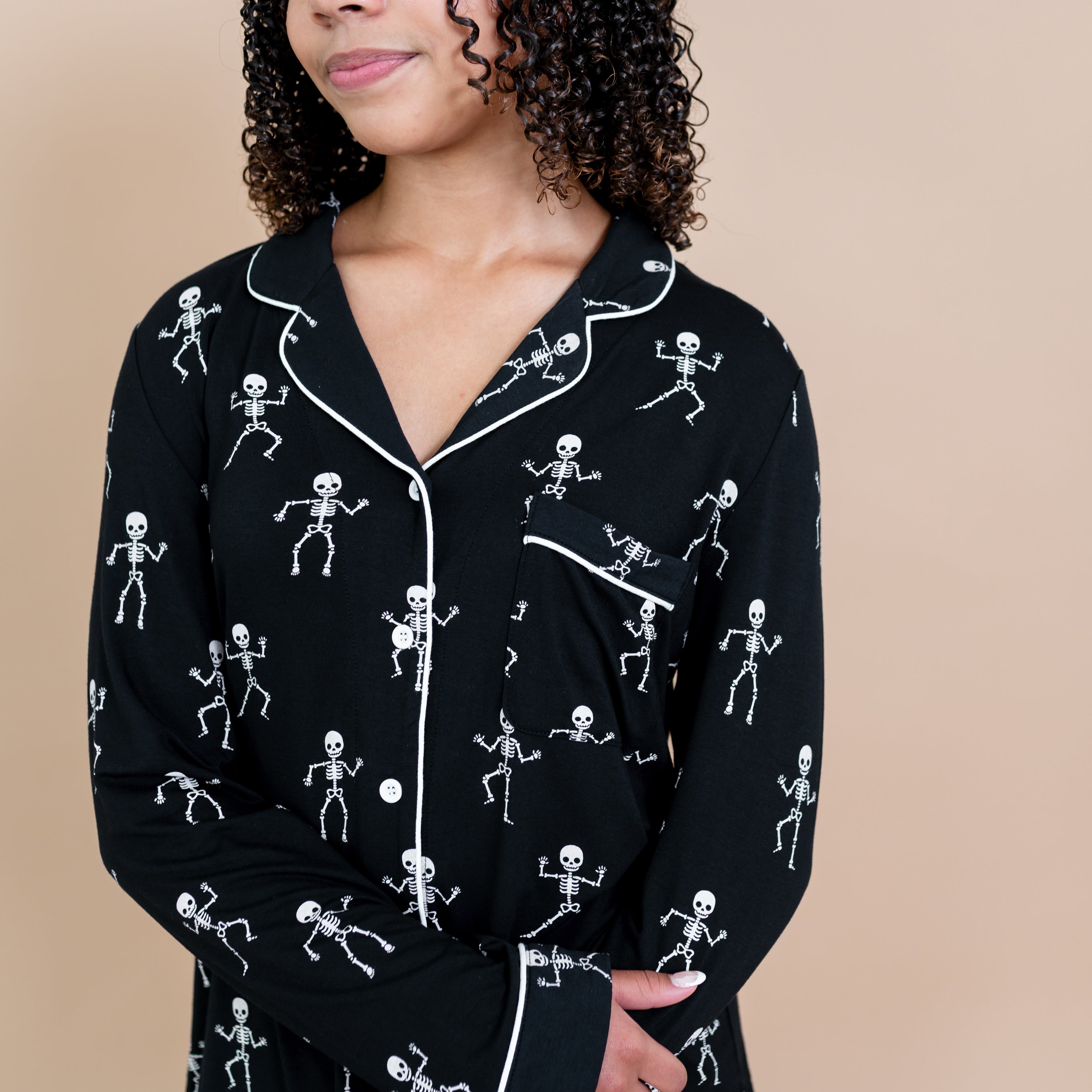 Close up of the Long-Sleeved Women's Pajama Set in Skeleton cloud trim detail and chest pocket on a model