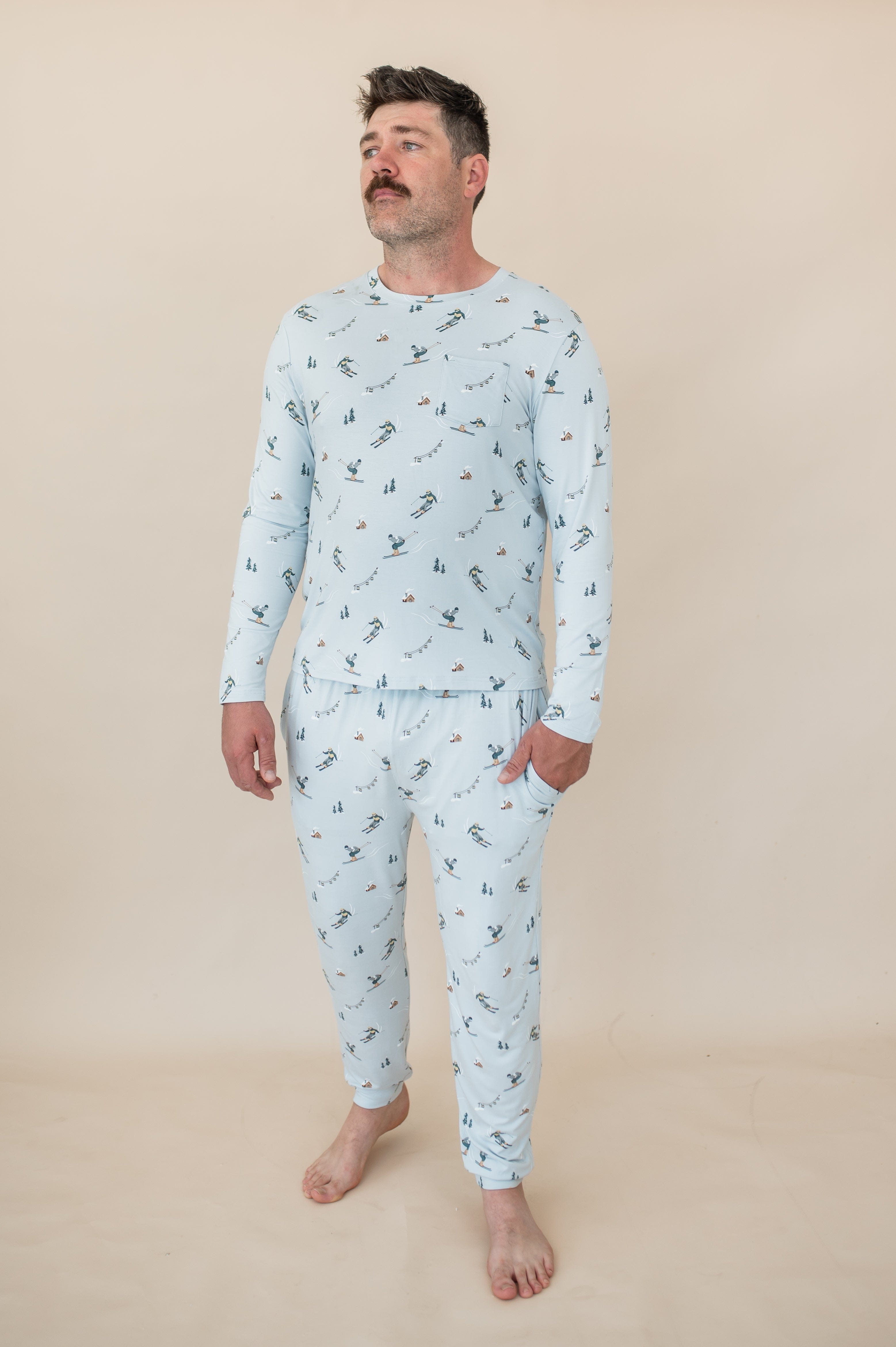 Male modeling the Men's Jogger Set in Ski standing in front of a light beige background with one hand in the jogger pants pocket