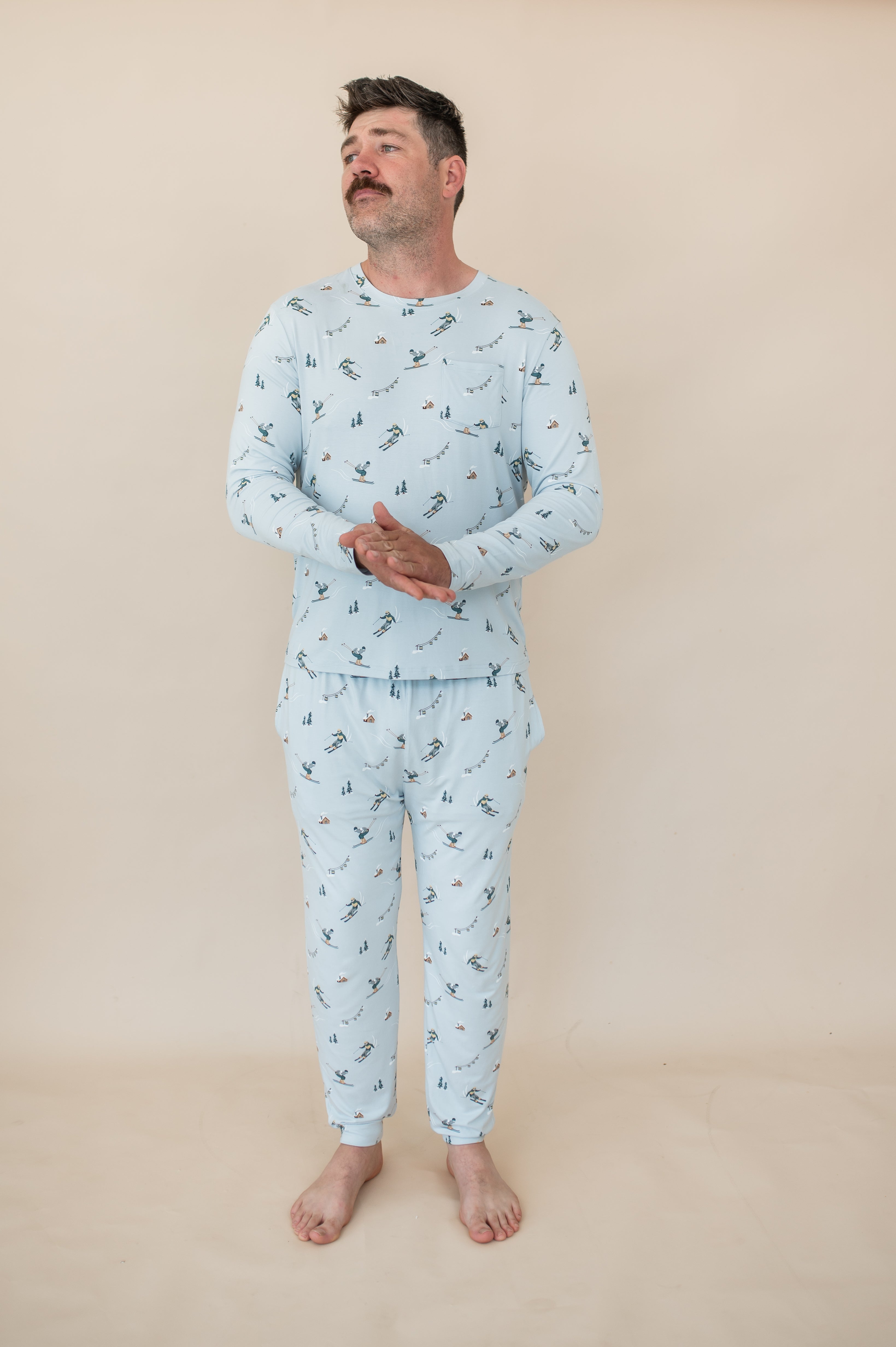 Male model standing wearing the Men's Jogger Set in Ski in front of a light beige background