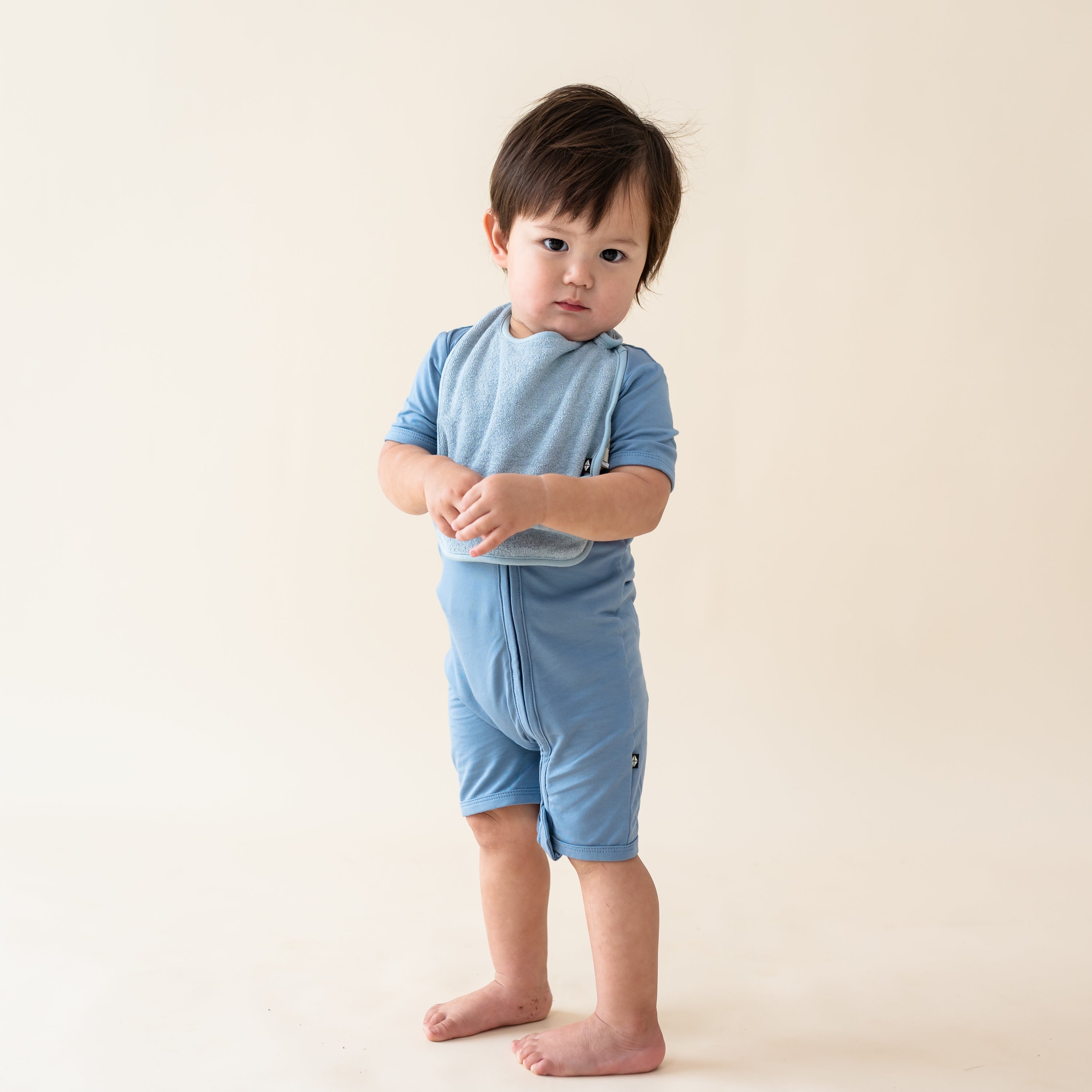 Toddler wearing Slate Blue Terry Pocket Bib with Adjustable Snaps