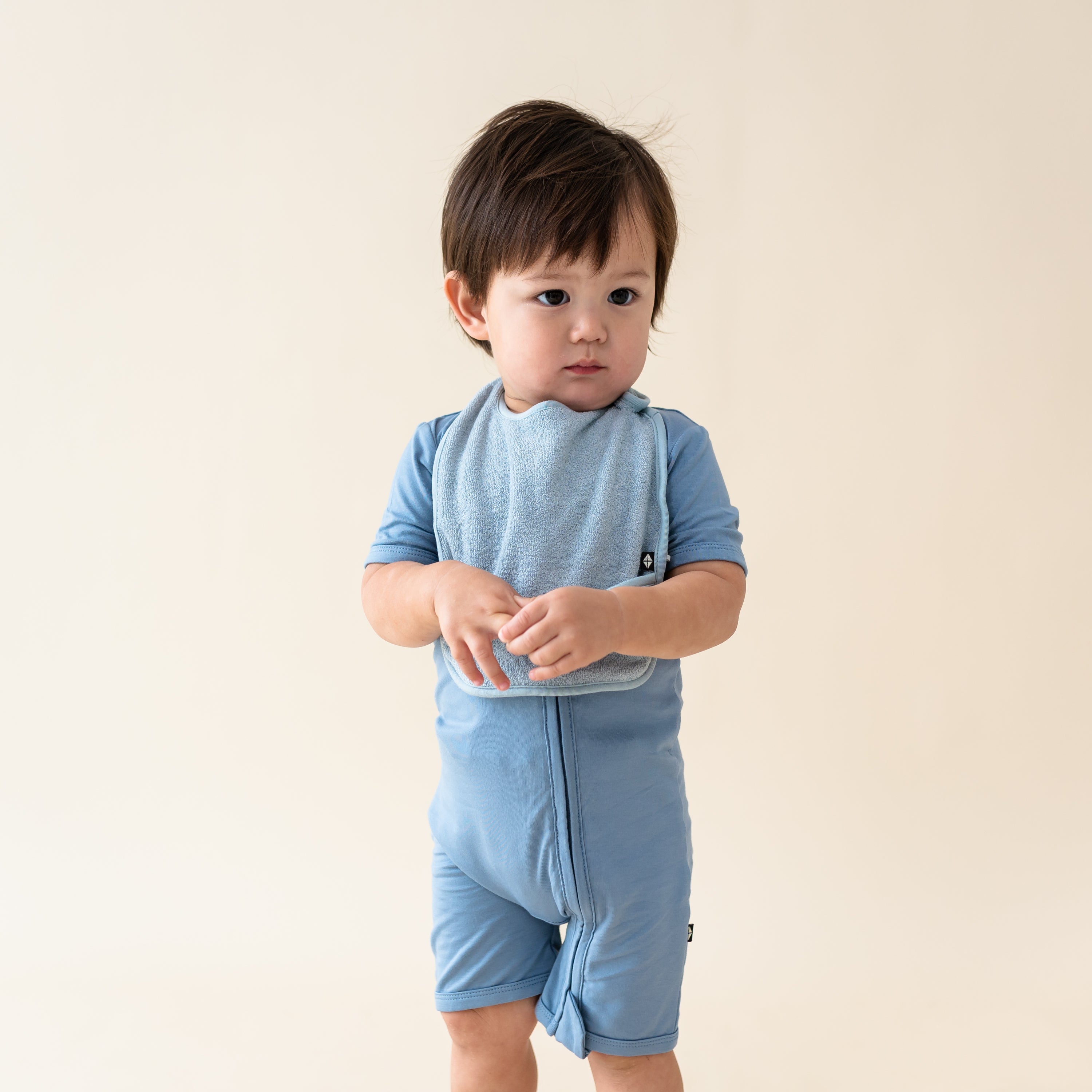 Toddler wearing Terry Pocket Bib in Slate