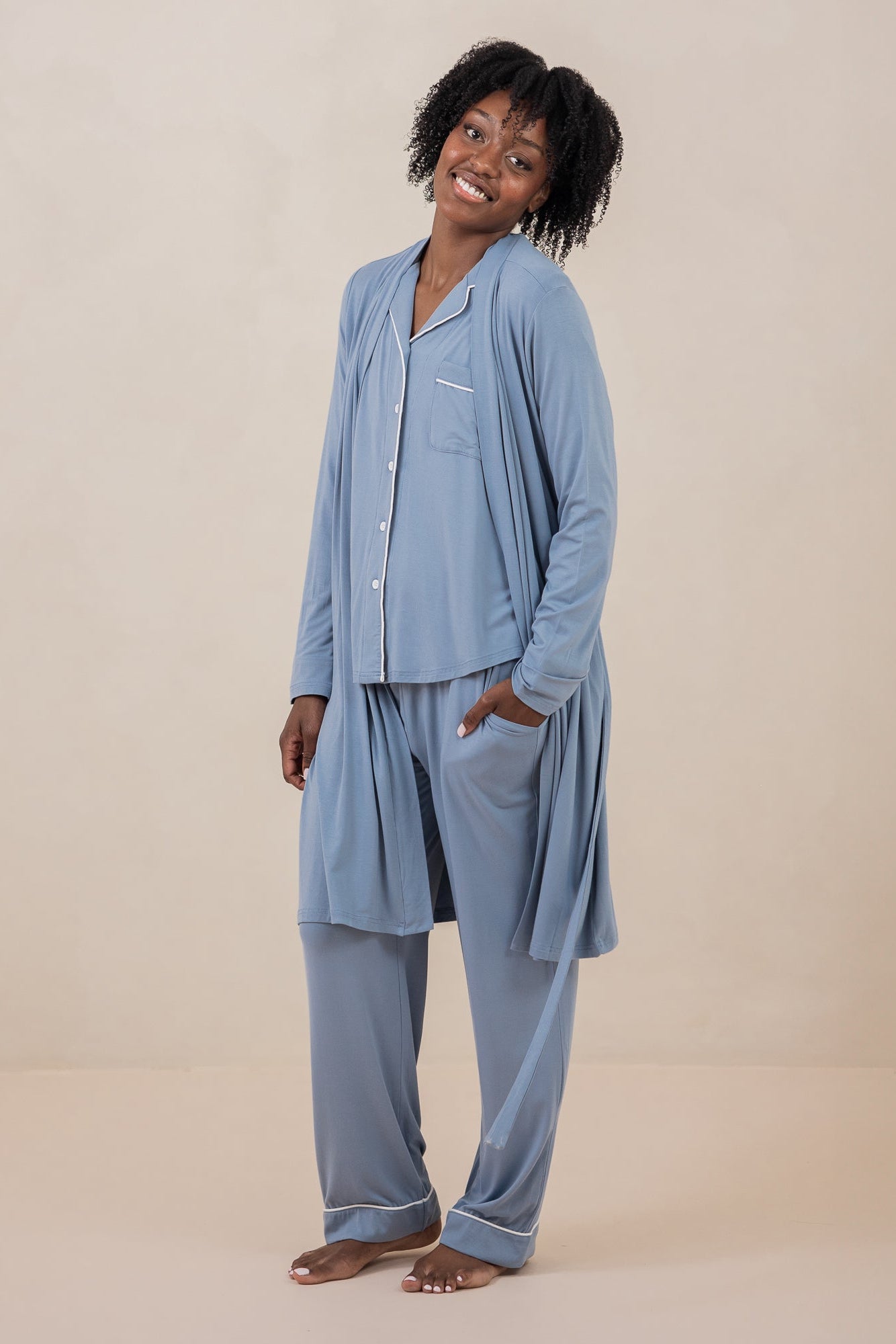Smiling female model wearing the Women's Lounge Robe in Slate untied with matching long sleeve women's pajama set on underneath