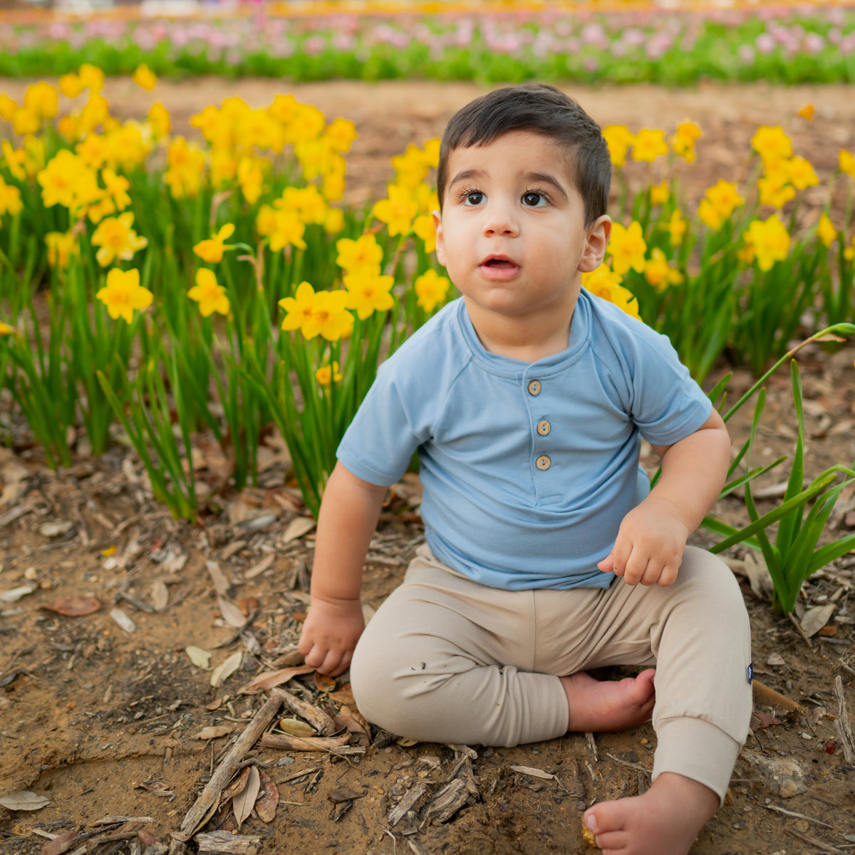 Toddler in Short Sleeve Toddler Henley Tee in Slate in tulip field
