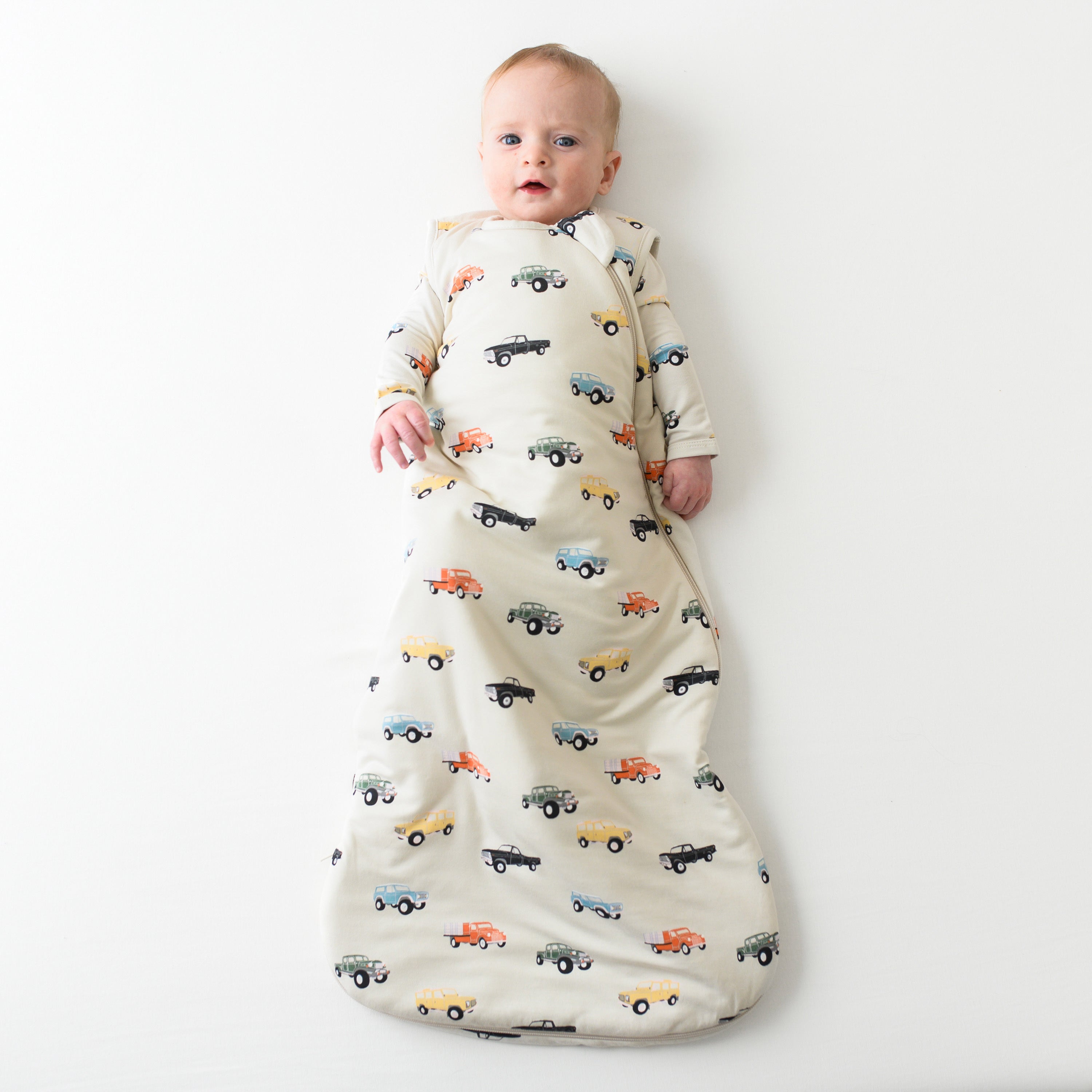 Infant model wearing the 1.0 Sleep Bag in Vintage Truck