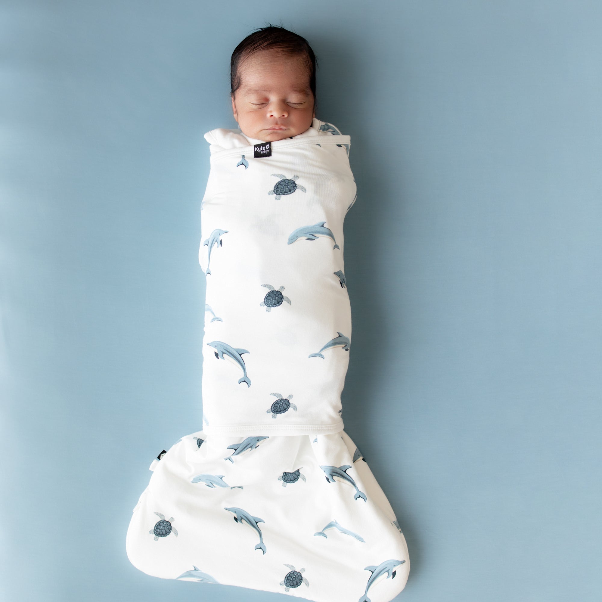 Baby sleeping swaddled in Sleep Bag Swaddler in Dolphin 1.0