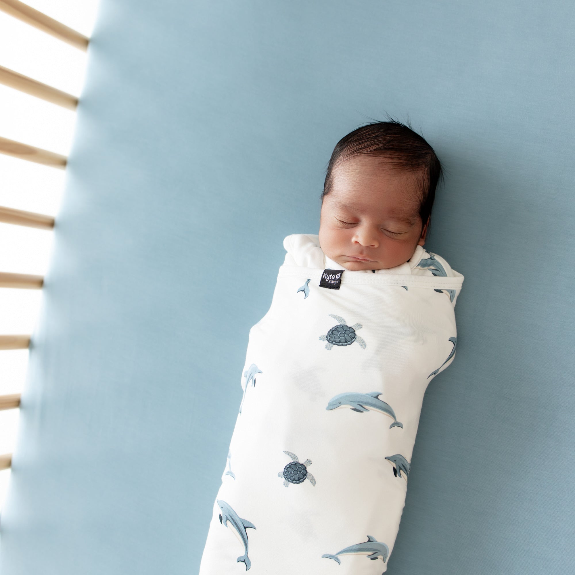 Close up of baby swaddled in Sleep Bag Swaddler in Dolphin 1.0
