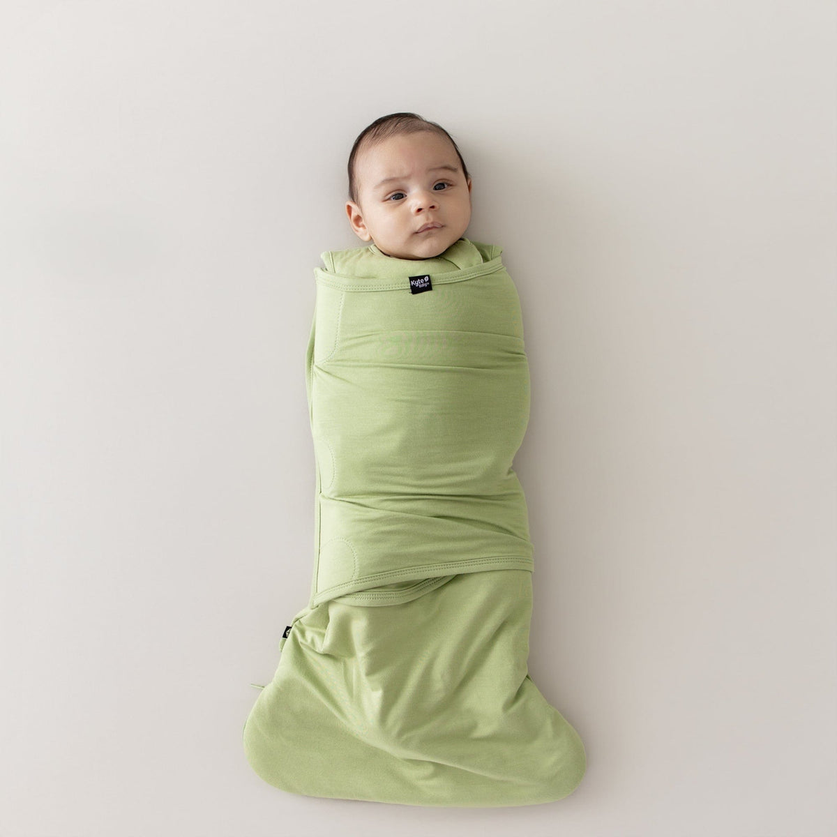 Baby swaddled in the Sleep Bag Swaddler in Honu 1.0