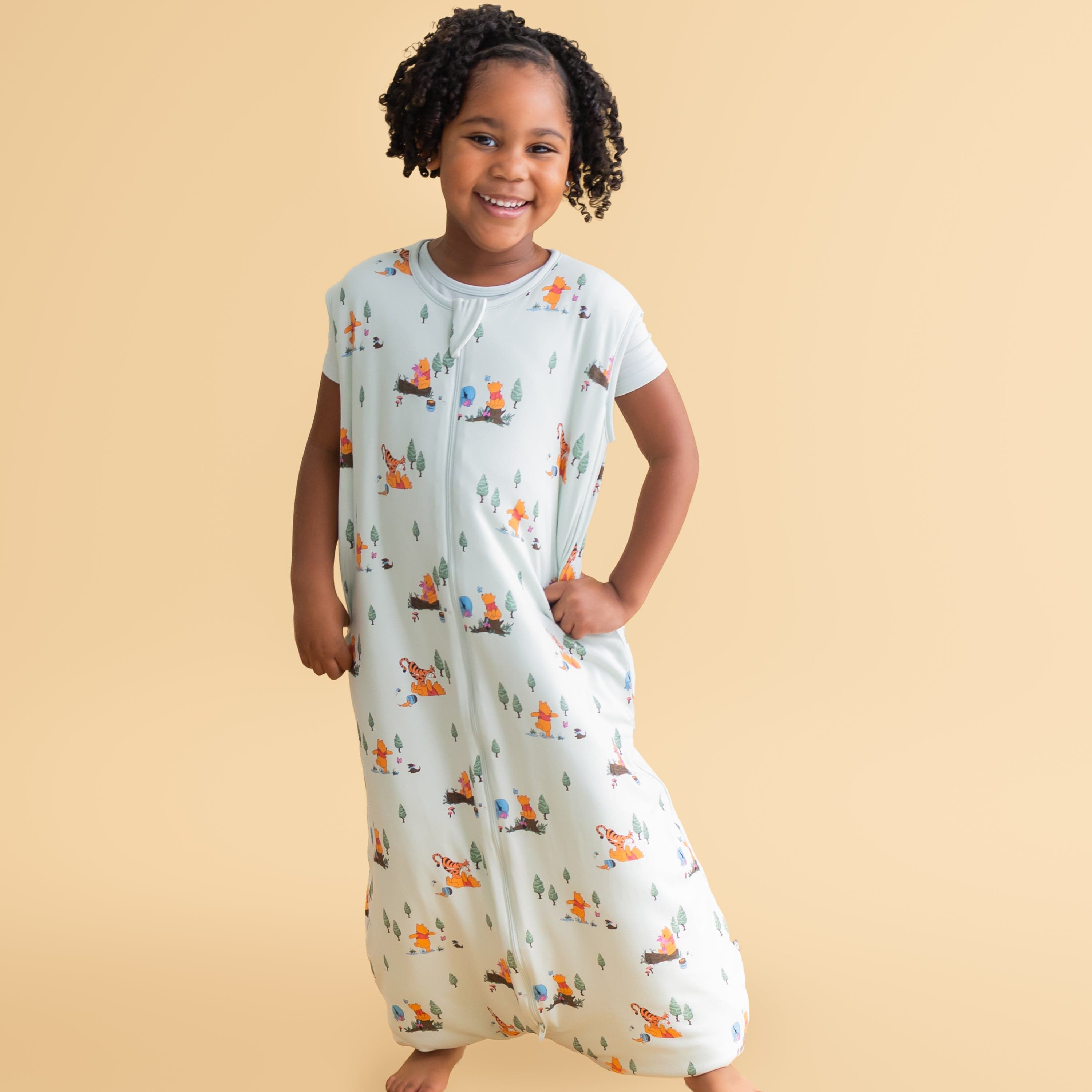 Young girl posing wearing the Sleep Bag Walker in Winnie the Pooh Hundred Acre Wood 1.0