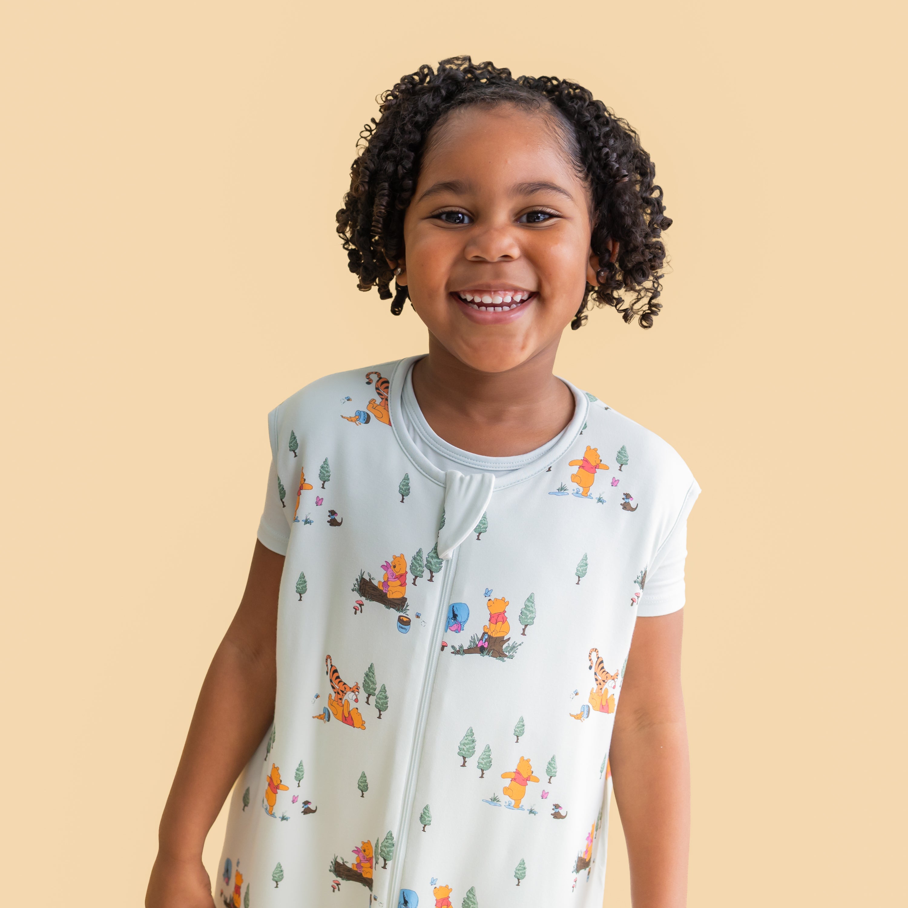 Close up of smiling girl wearing the Sleep Bag Walker in Winnie the Pooh Hundred Acre Wood 1.0