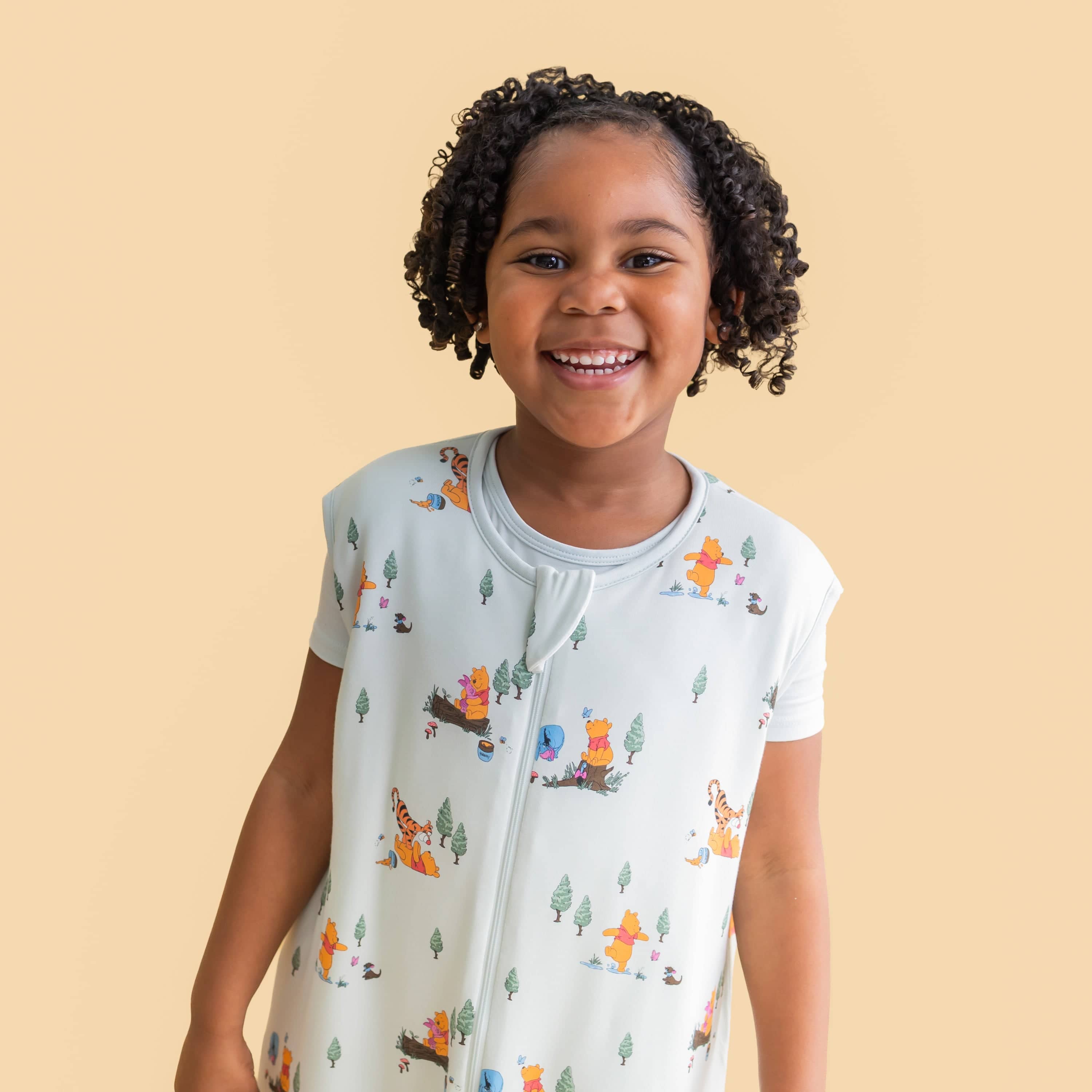 Close up of smiling girl wearing the Sleep Bag Walker in Winnie the Pooh Hundred Acre Wood 1.0