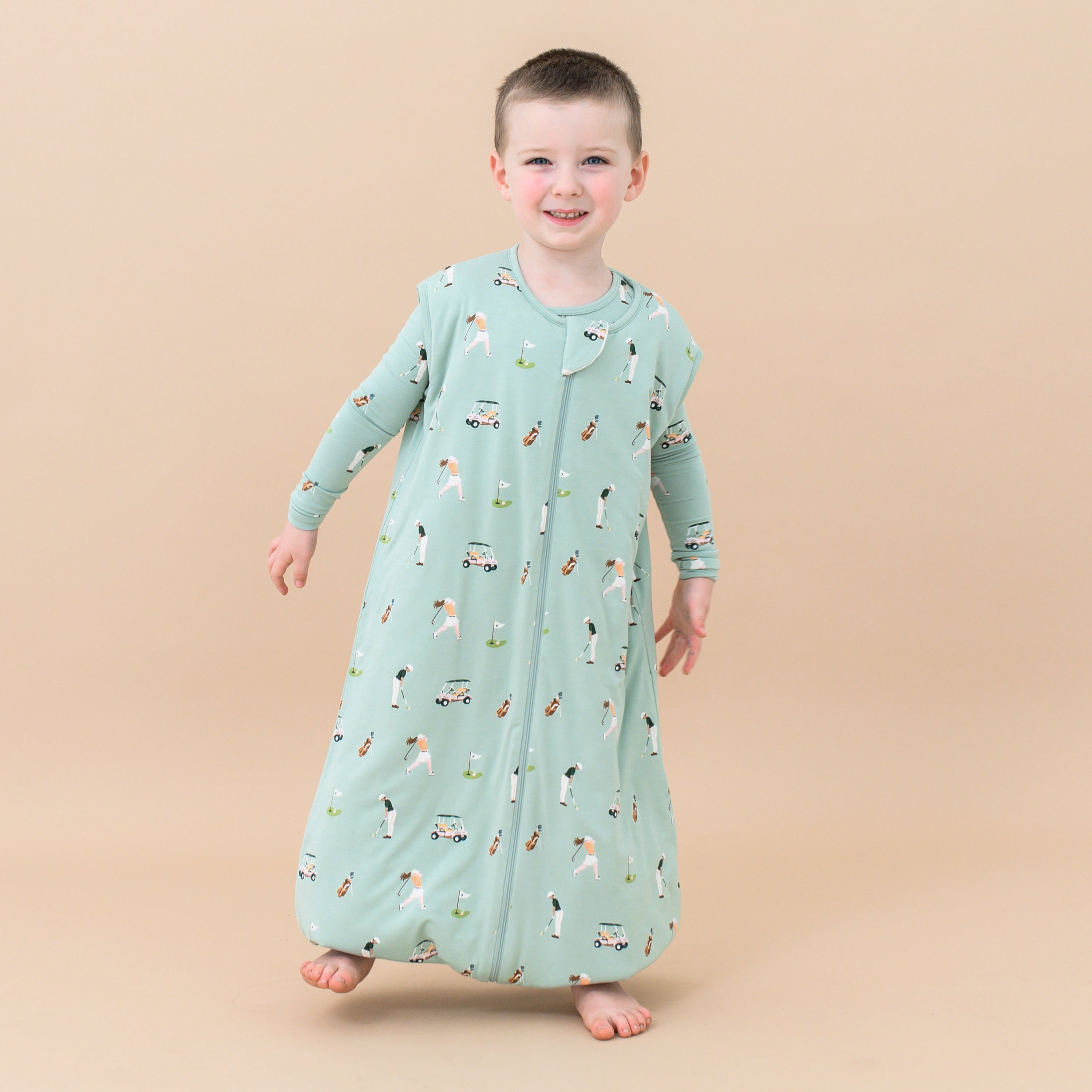 Toddler standing on one leg wearing Sleep Bag Walker in Golf 1.0