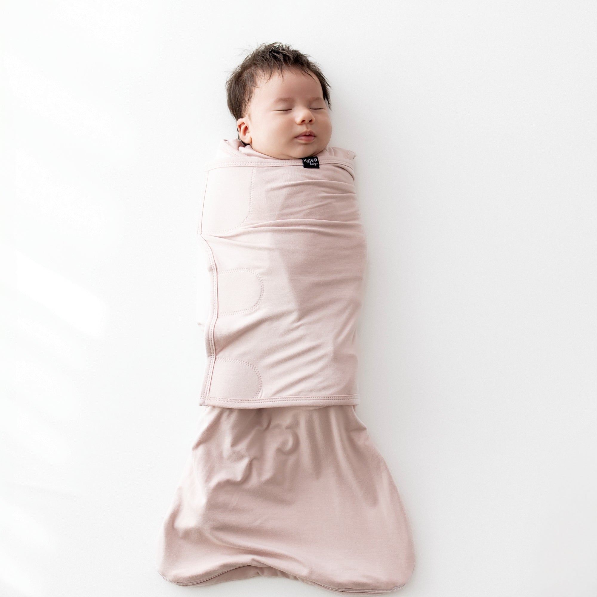 Baby sleeping swaddled in Sleep Bag Swaddler in Blush 0.5