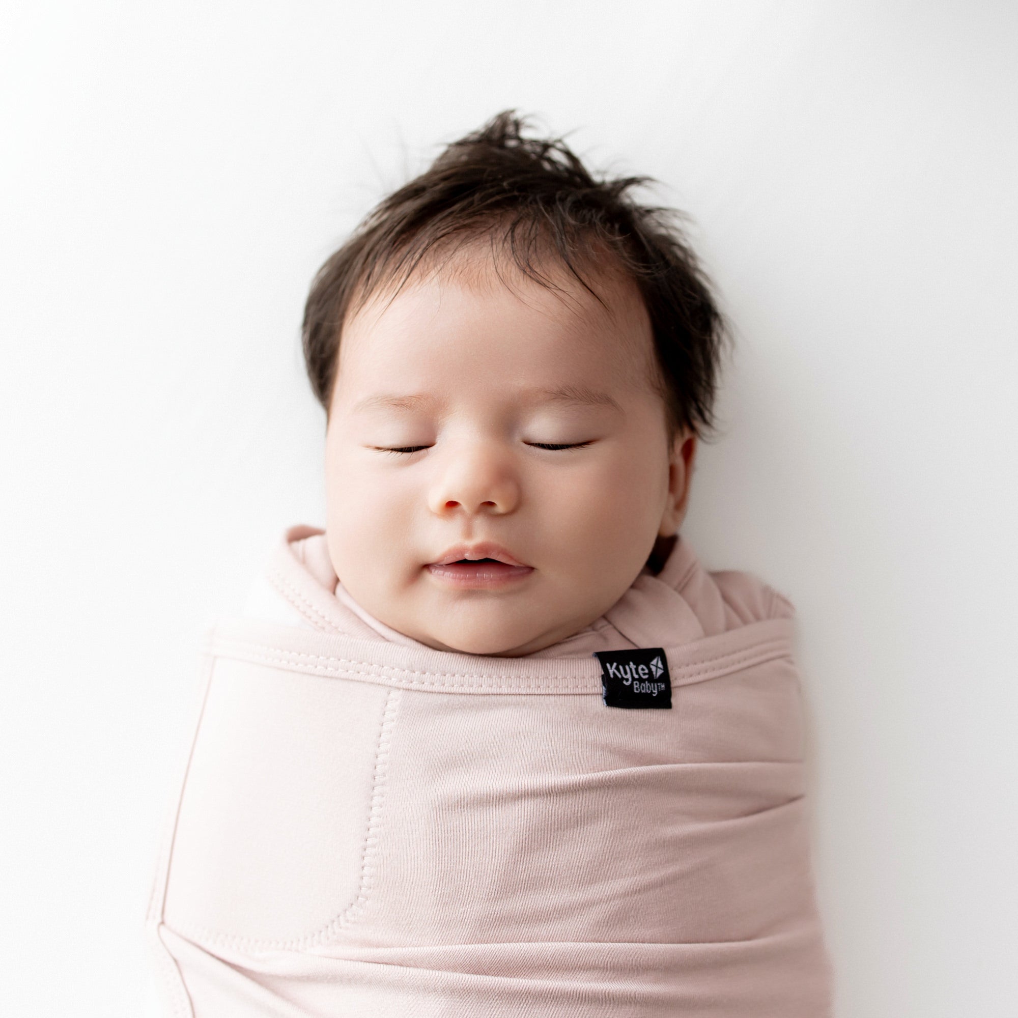 close up of Baby sleeping in Sleep Bag Swaddler in Blush 0.5