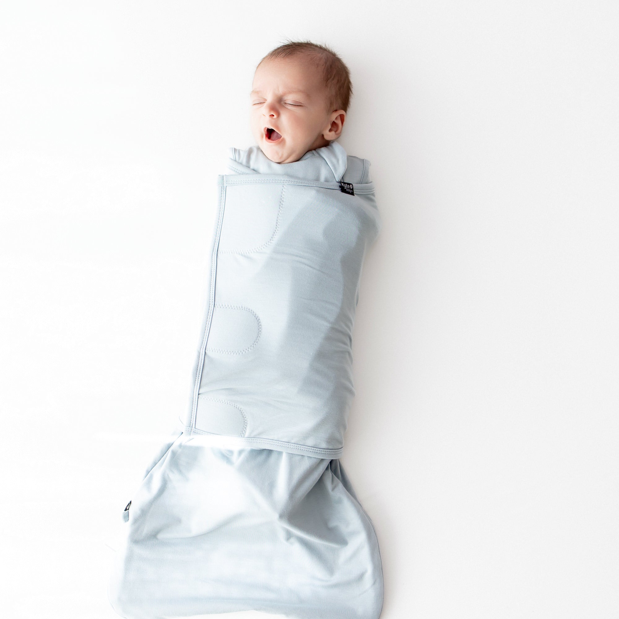 Baby sleeping swaddled in Sleep Bag Swaddler in Fog 0.5
