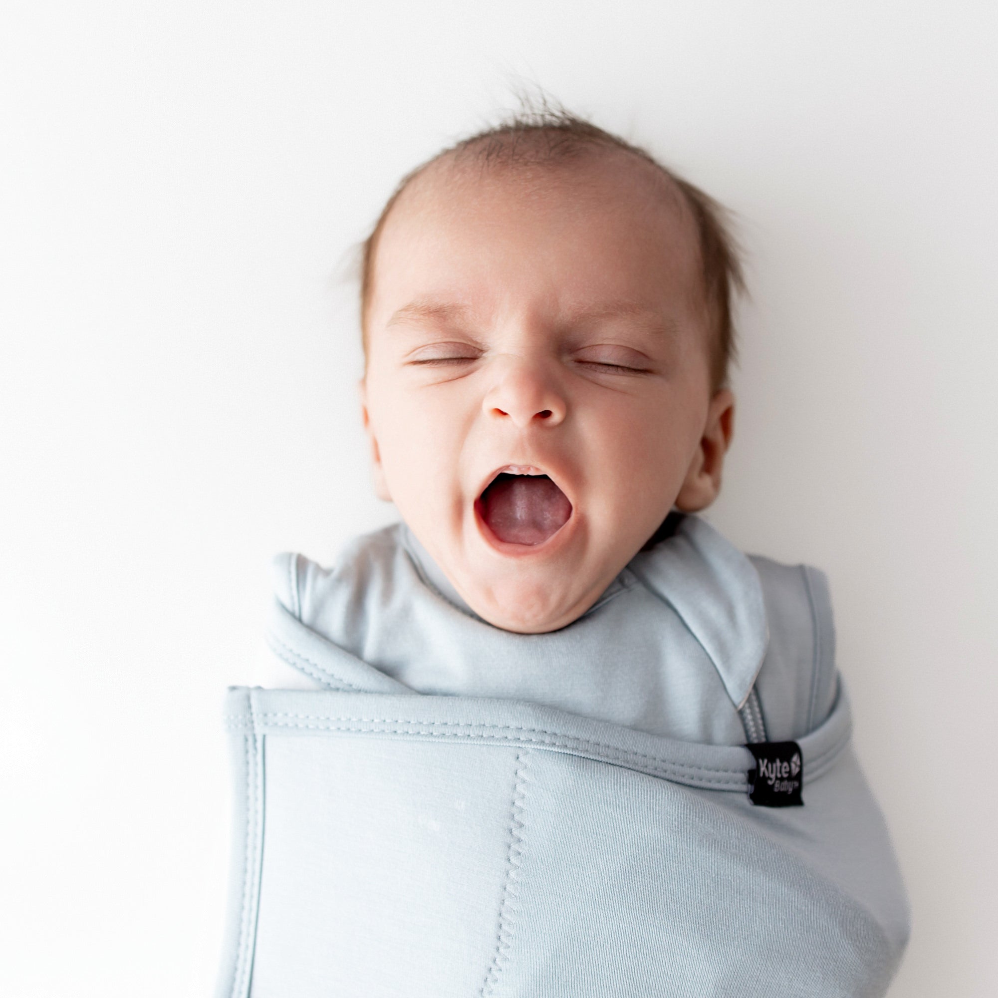 Baby yawning in Sleep Bag Swaddler in Fog 0.5