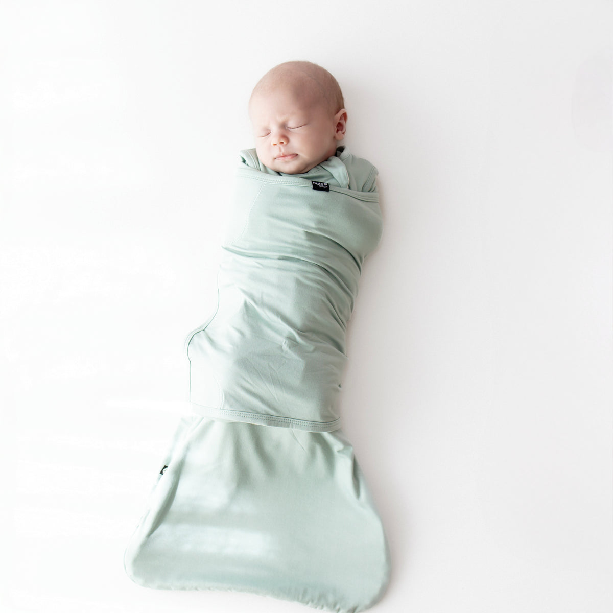 Baby sleeping swaddled in Sleep Bag Swaddler in Sage 0.5