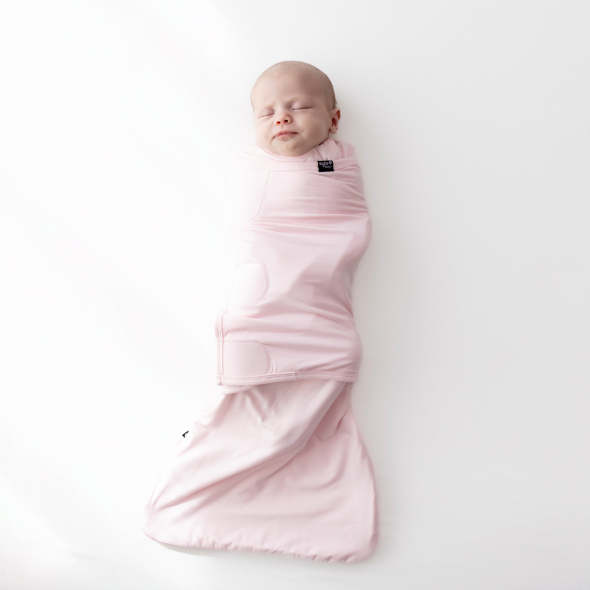 Baby asleep swaddled in Sleep Bag Swaddler in Sakura 0.5