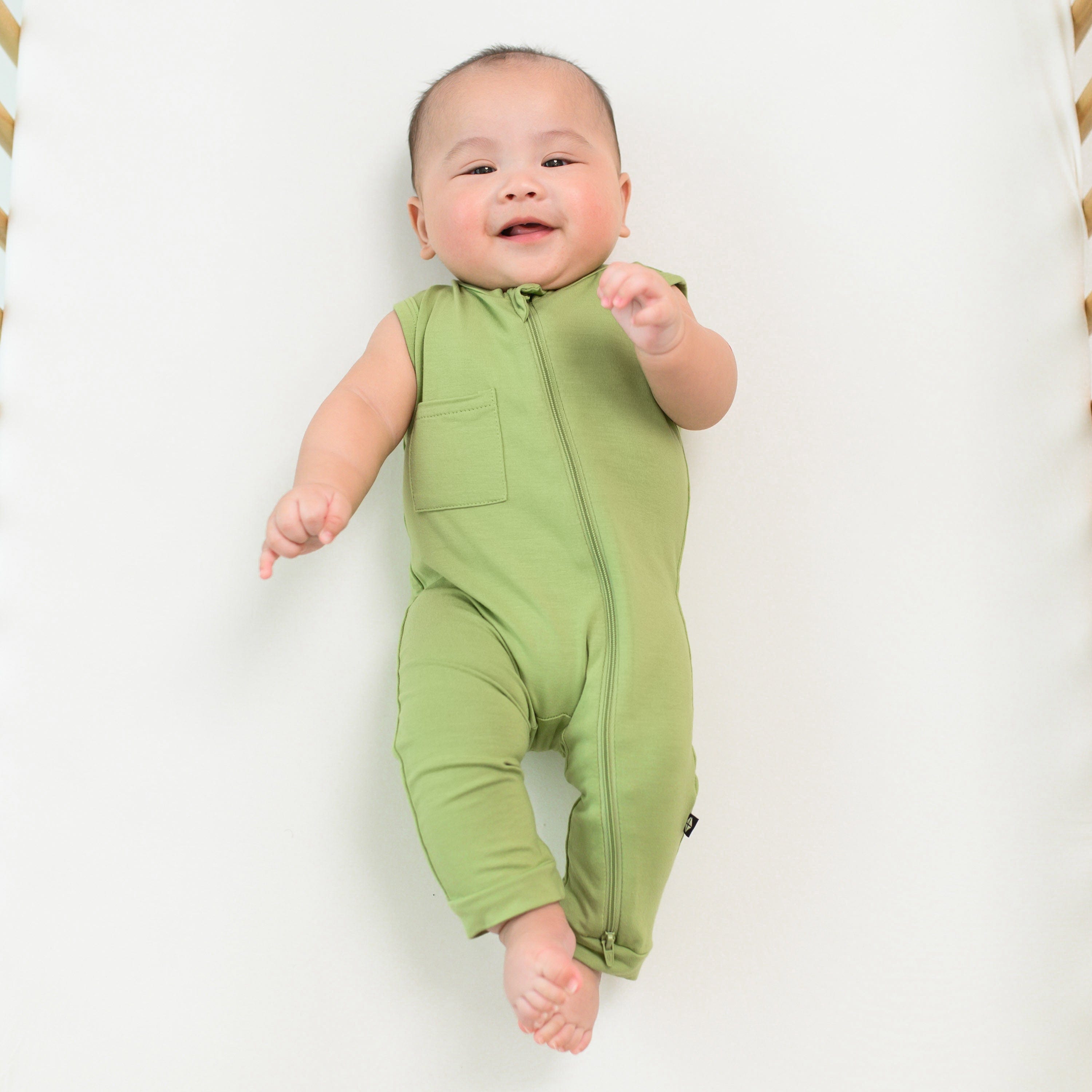 Infant wearing Kyte Baby Sleeveless Zippered Romper with dual zipper in Honu