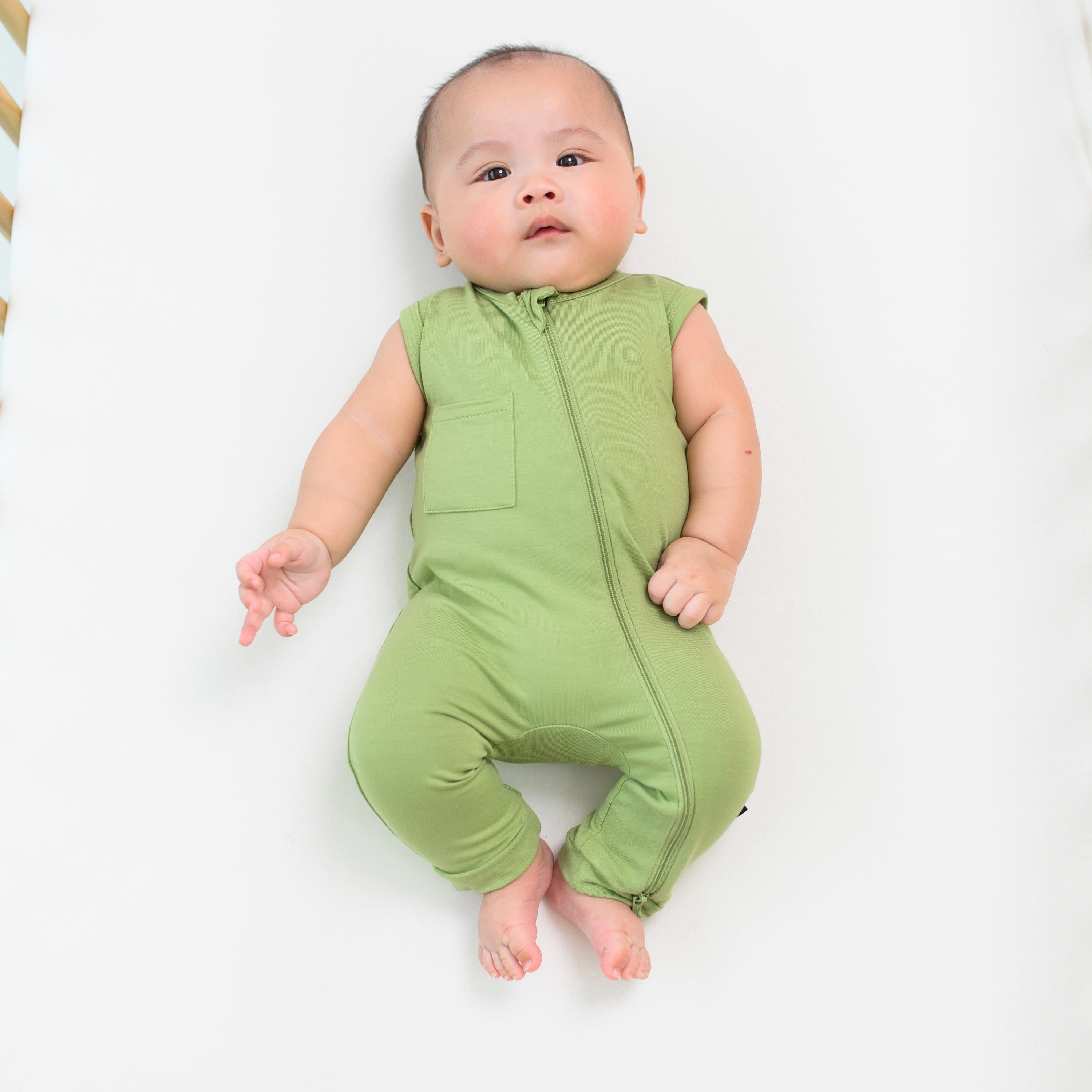 Infant wearing Kyte Baby Sleeveless Zippered Romper in Honu green