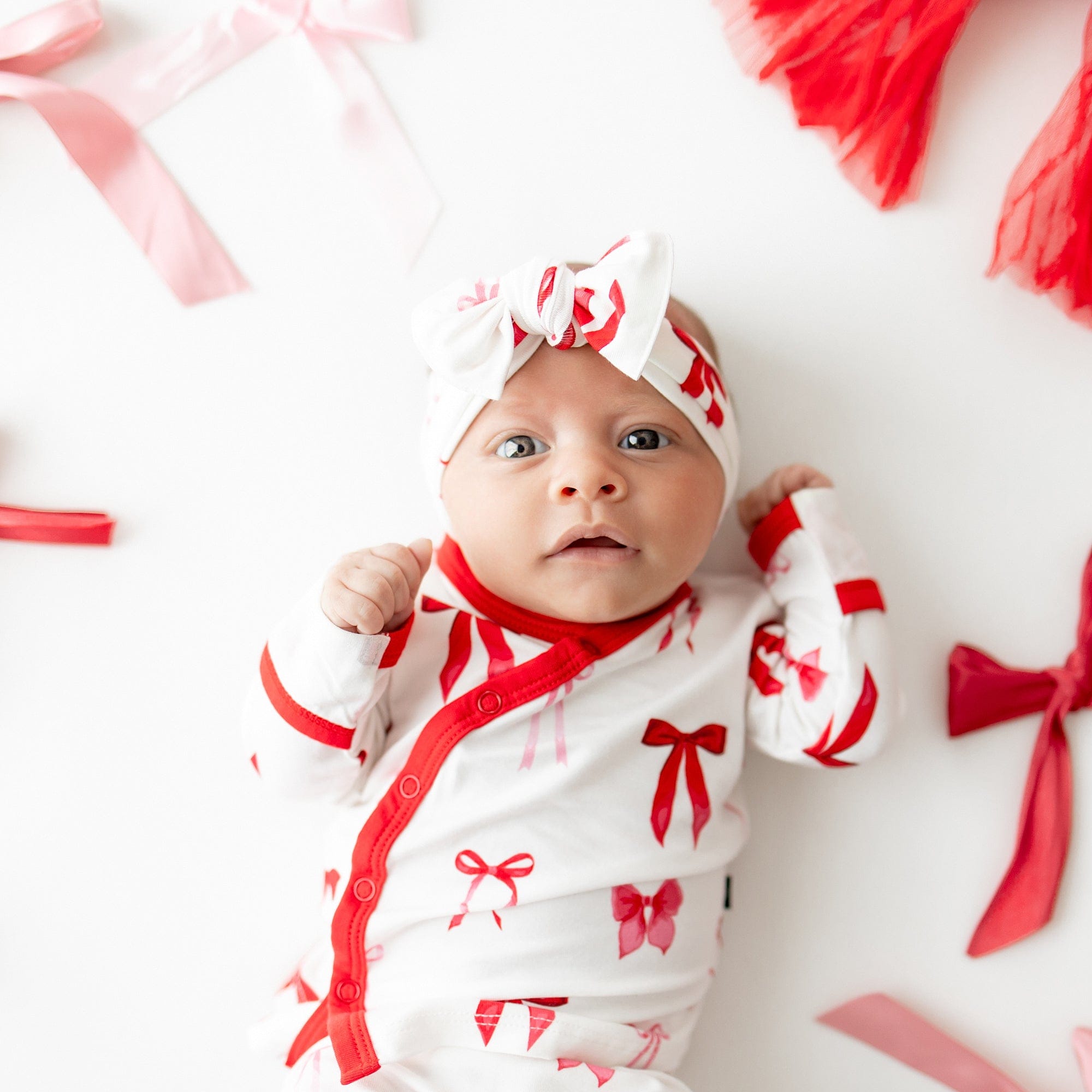 Close up of newborn wearing the Take Me Home Set with Bow in Small Love Bow