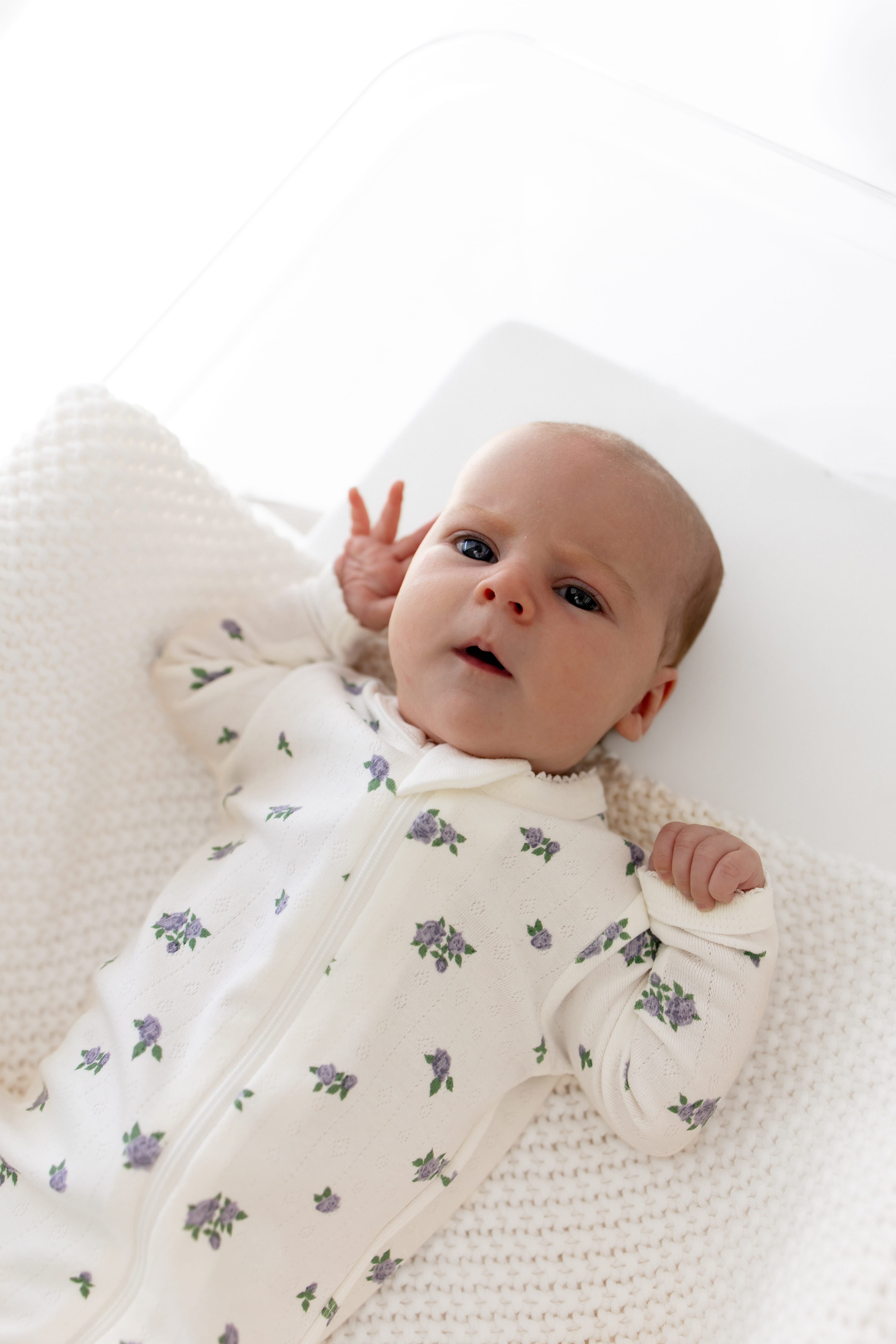Close up of newborn wearing the Pointelle Zippered Footie in Spray Rose
