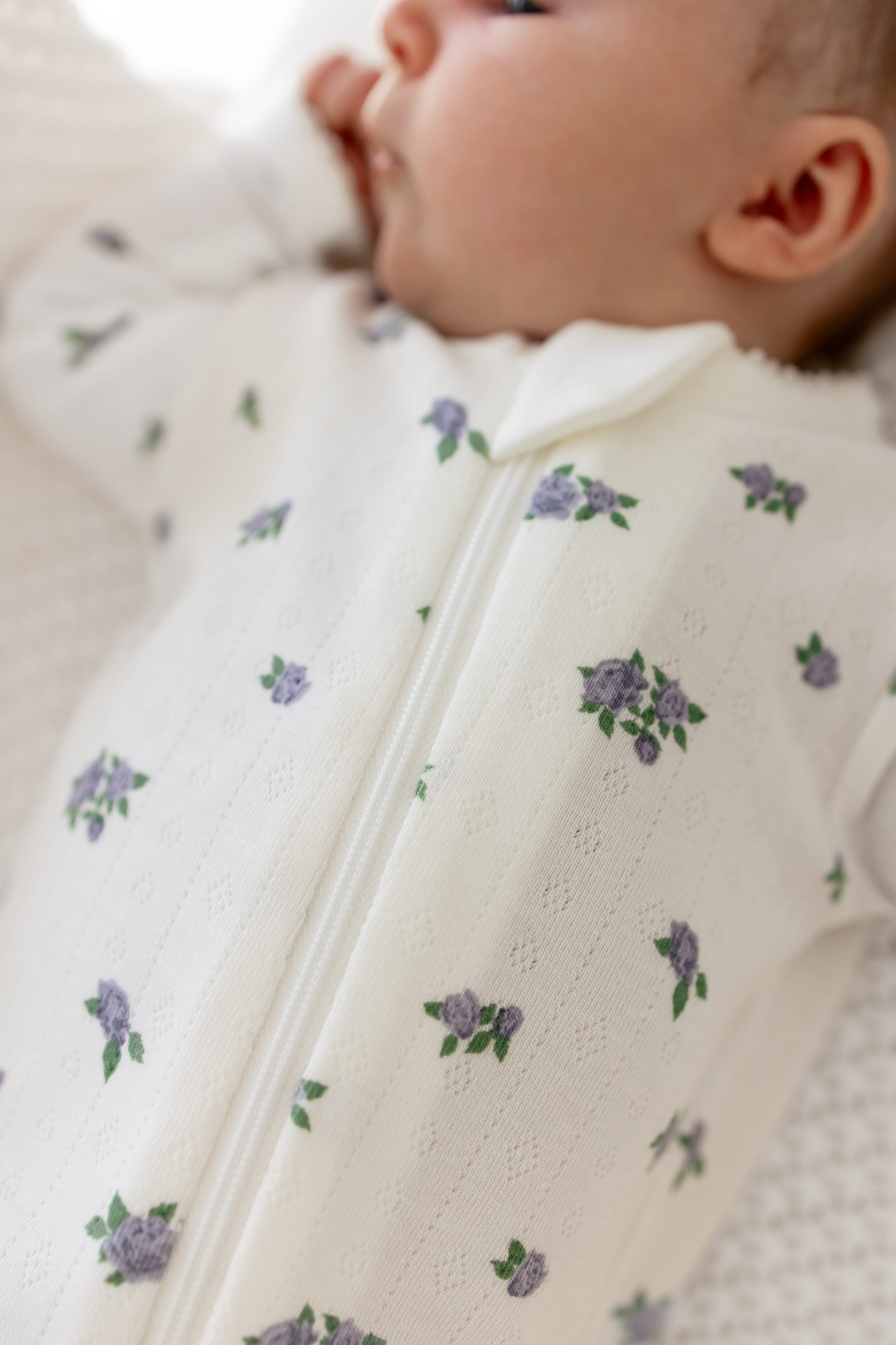 Close up of the pointelle fabric and zipper closure on the Pointelle Zippered Footie in Spray Rose