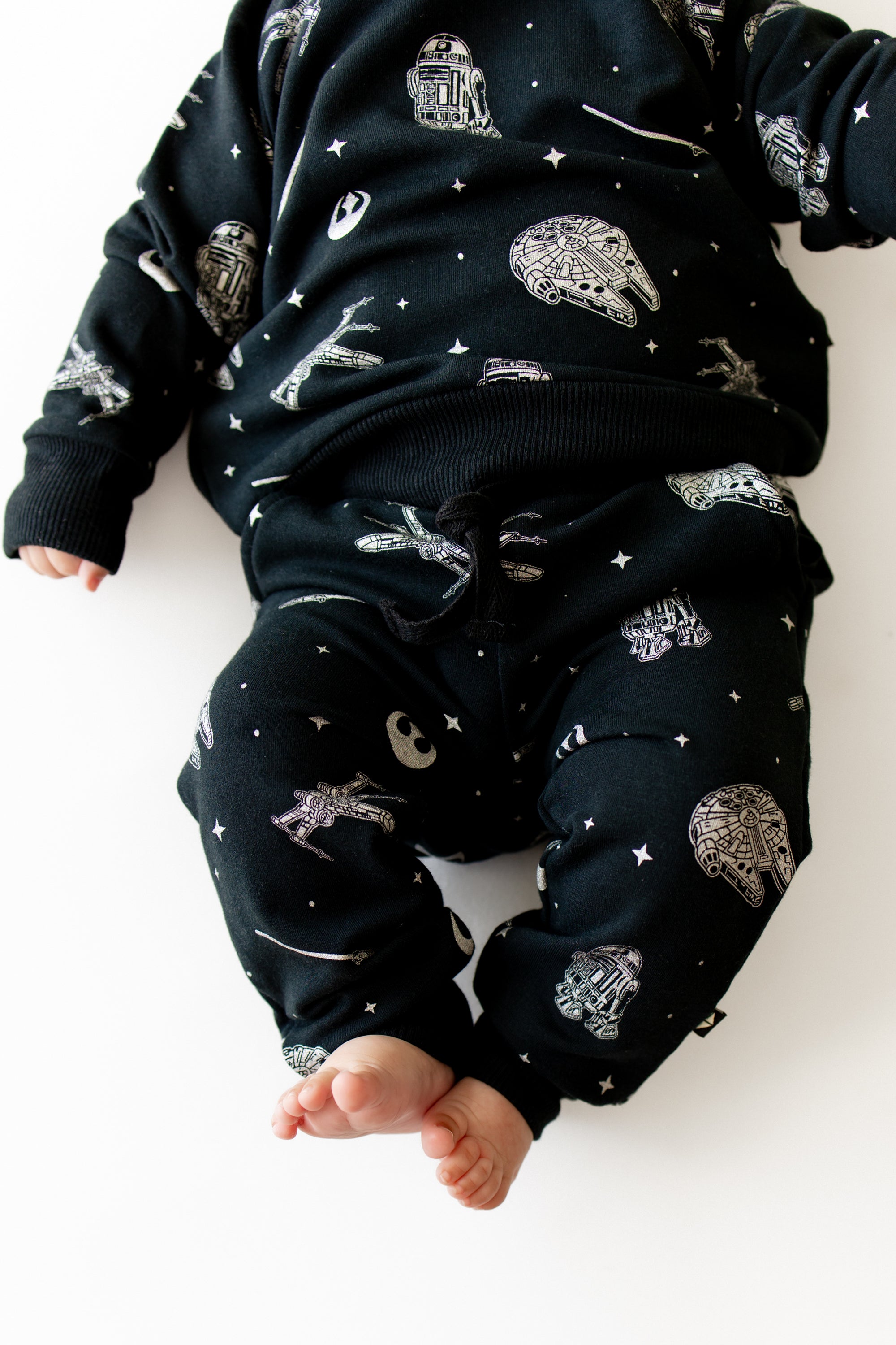 Close up of the pants and shirt of the Long Sleeve Jogger Set in STAR WARS™ shown on an infant