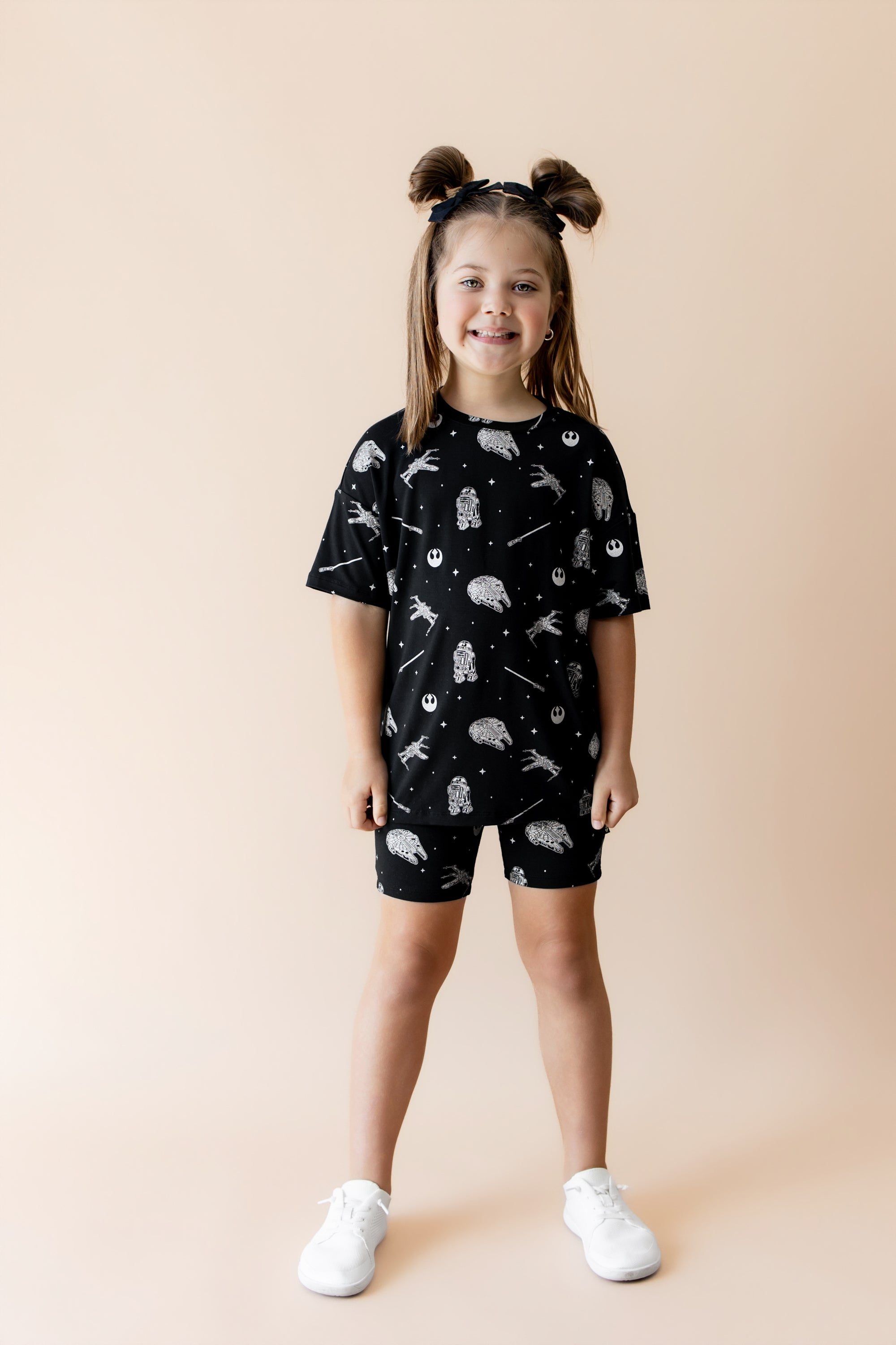 Young girl modeling the Toddler Biker Short Set in STAR WARS™ paired with white shoes