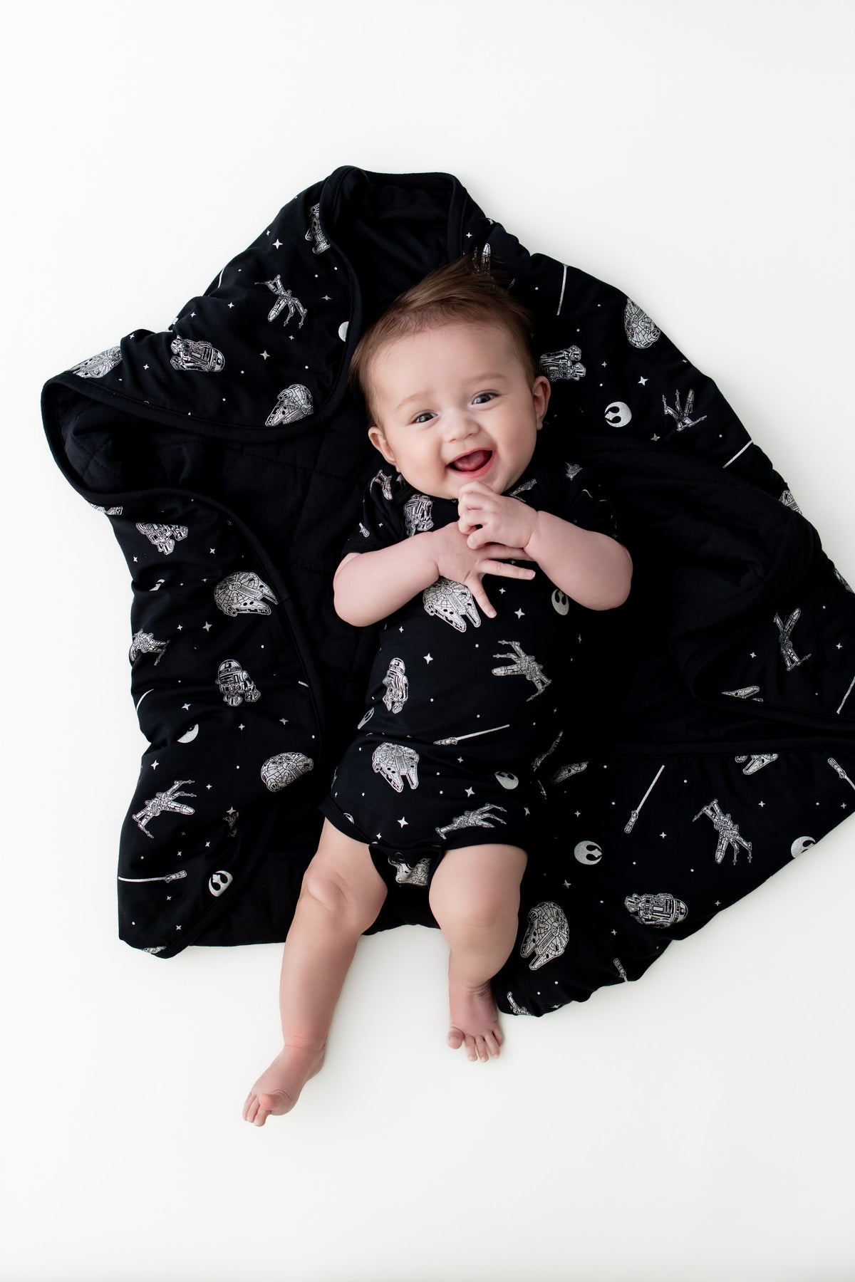 Infant laying on the Baby Blanket in STAR WARS™ wearing a matching short sleeve bodyuit