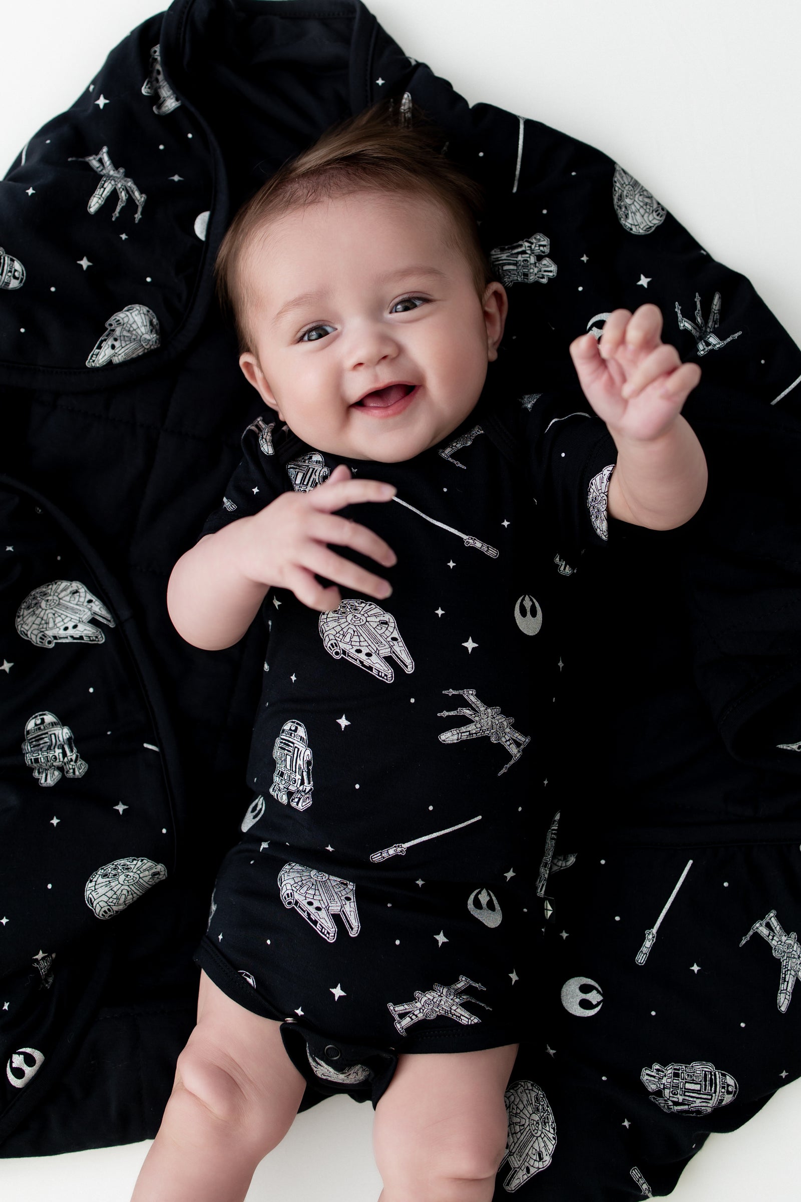 Close up of infant laying on a Baby Blanket in STAR WARS™ wearing a matching short sleeve bodysuit