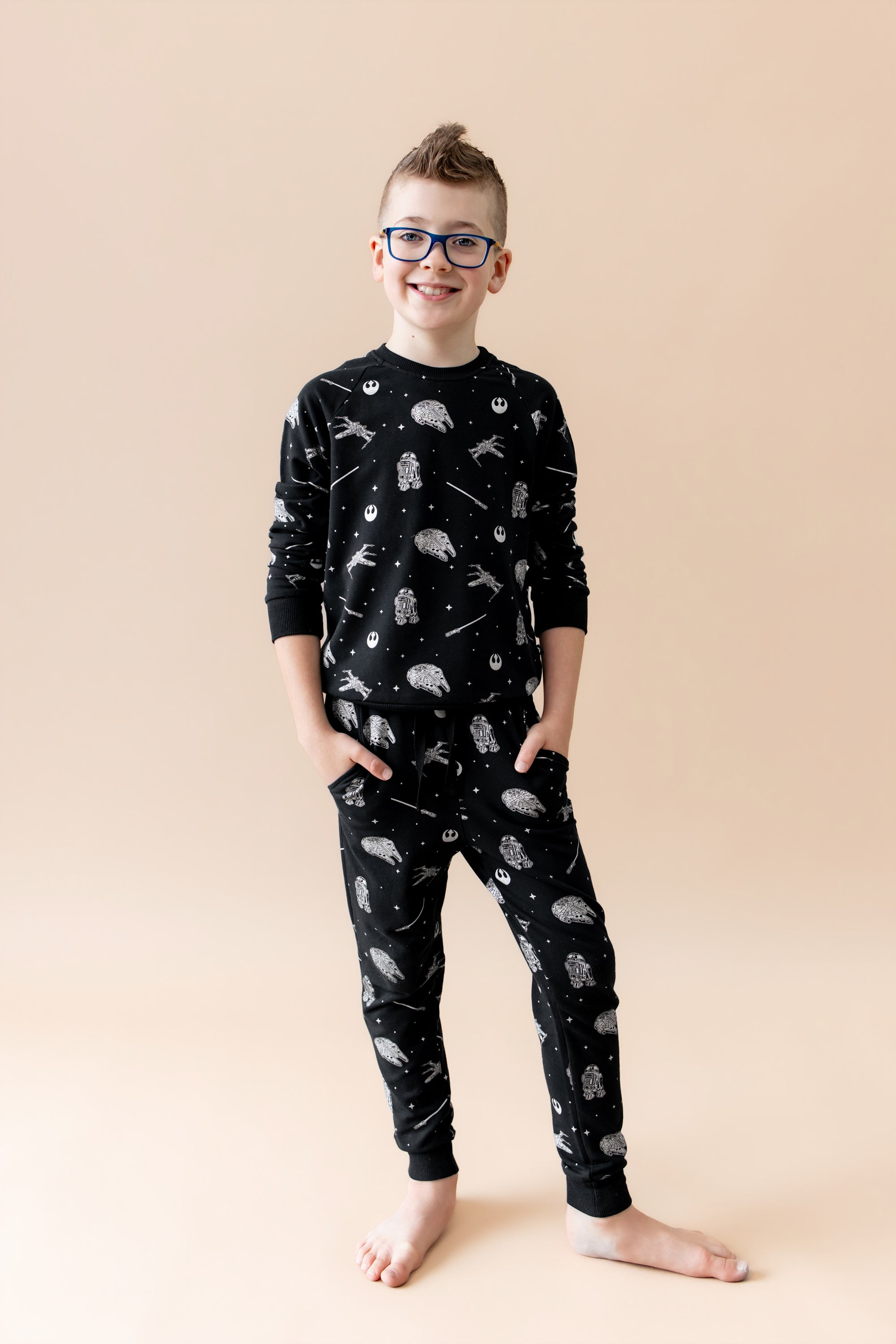 Young boy modeling the Long Sleeve Jogger Set in STAR WARS™ with his hands in the side pockets