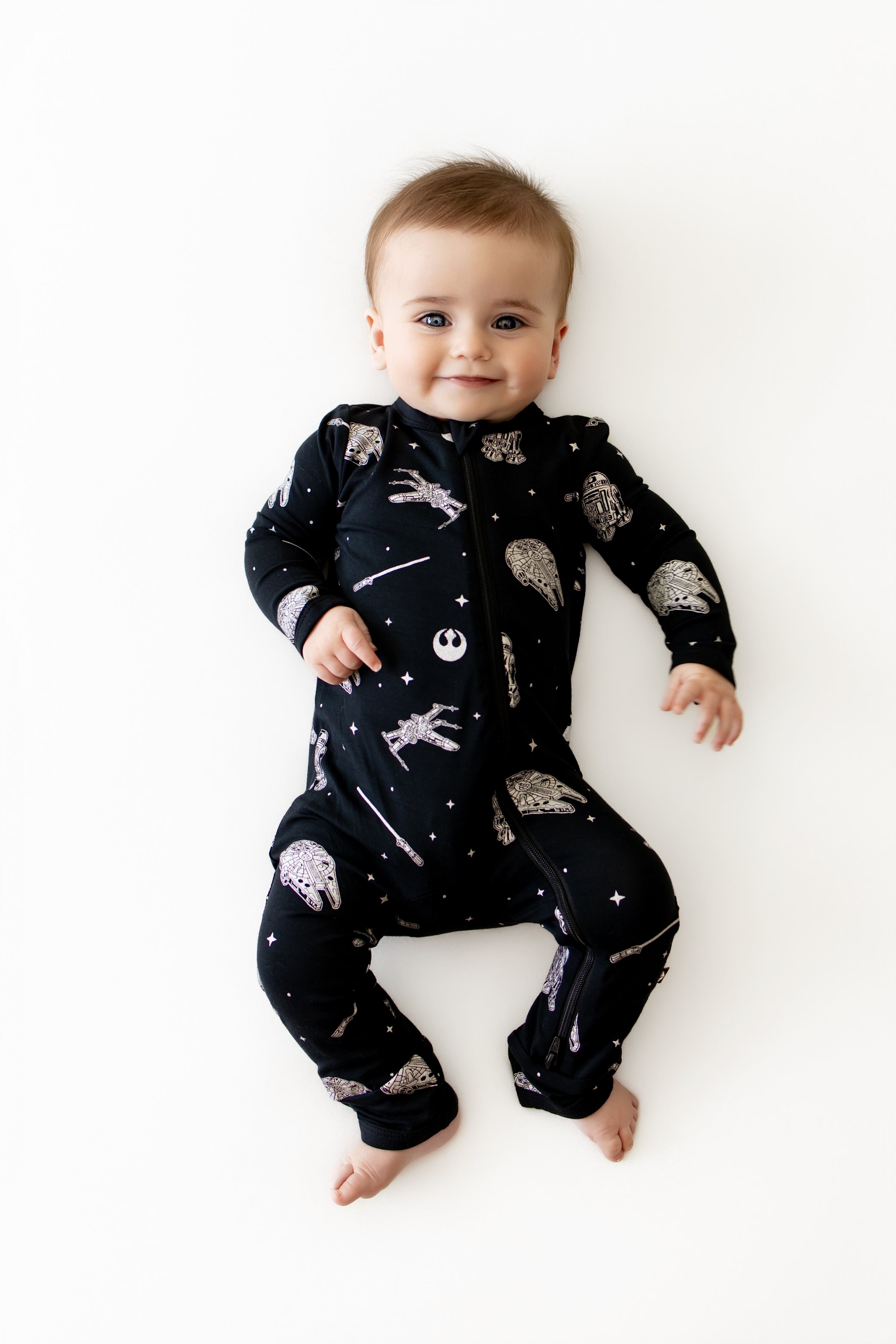 Smiling infant wearing the Zippered Romper in STAR WARS™