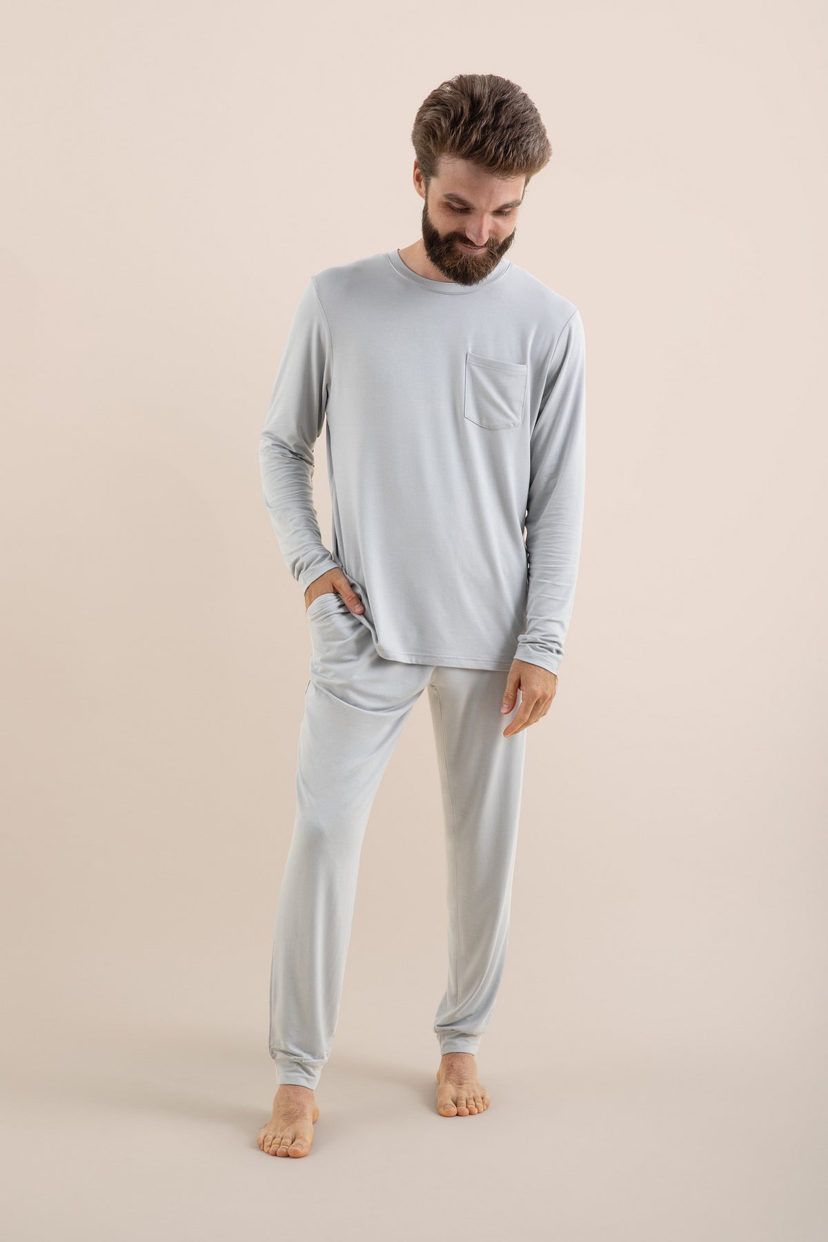 Male modeling the Men's Jogger Set in Storm in front of a light beige background