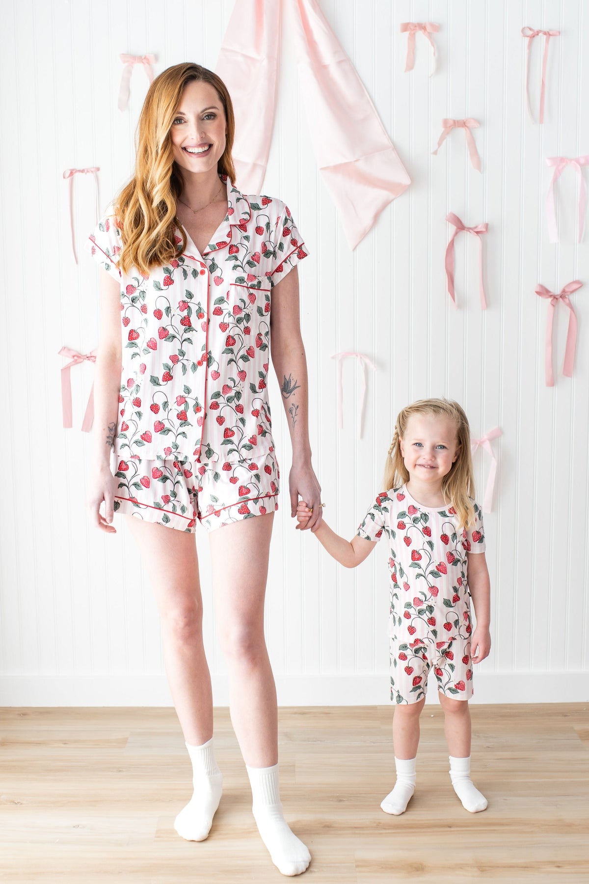 Mother and daughter holding hands wearing matching pajamas in Strawberry Fields