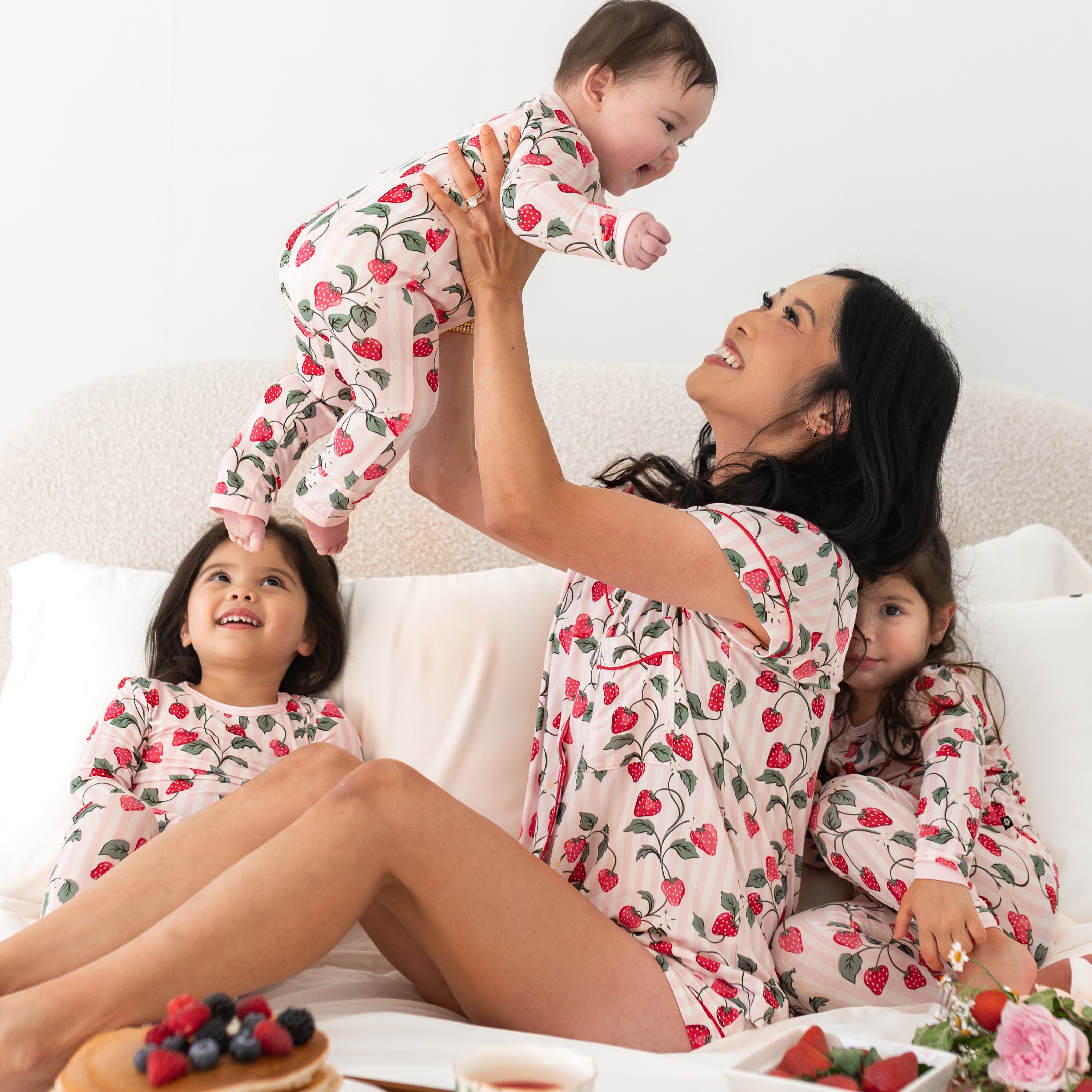Family in matching strawberry pajamas