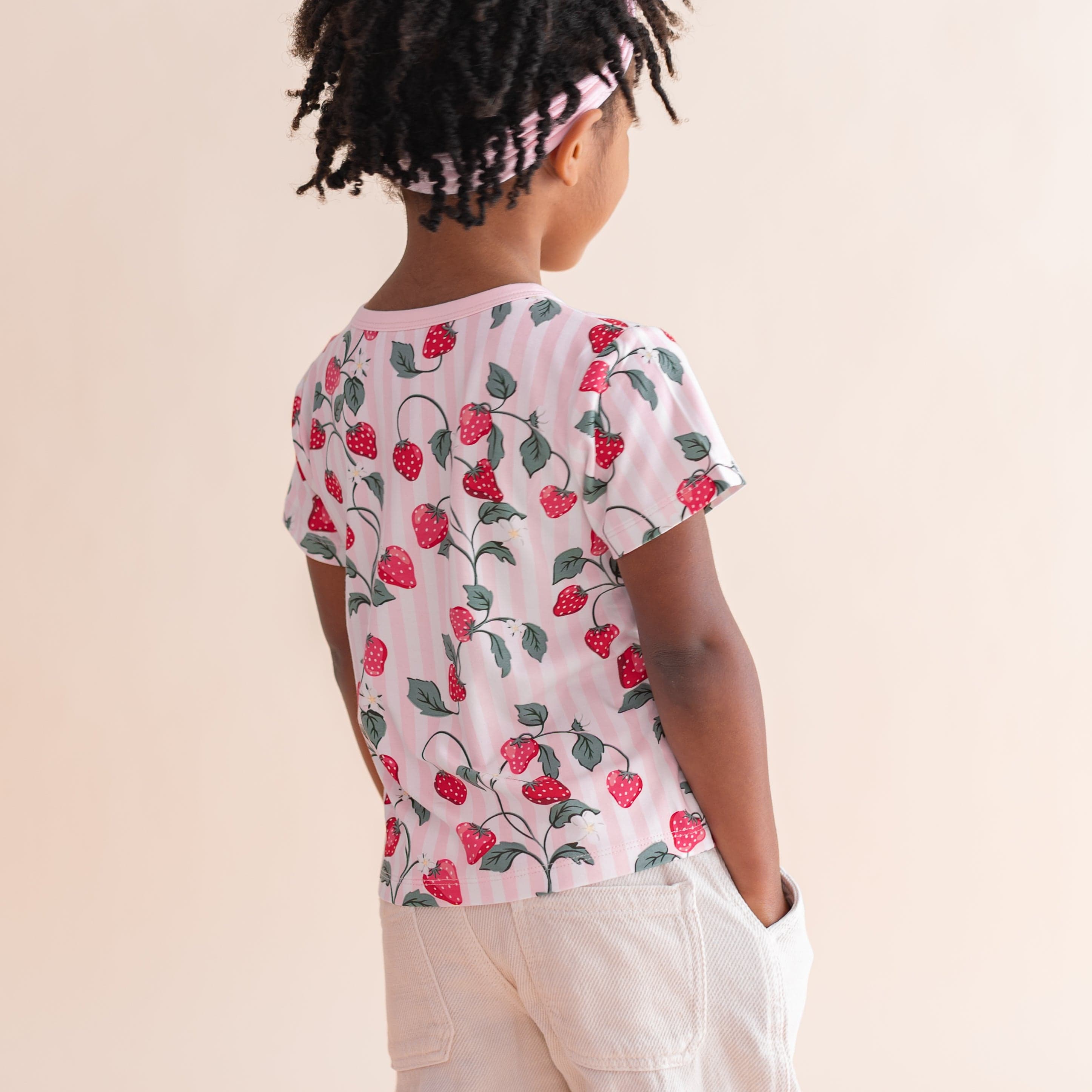 The back of the Toddler Basic Tee in Strawberry Fields shown on a young girl