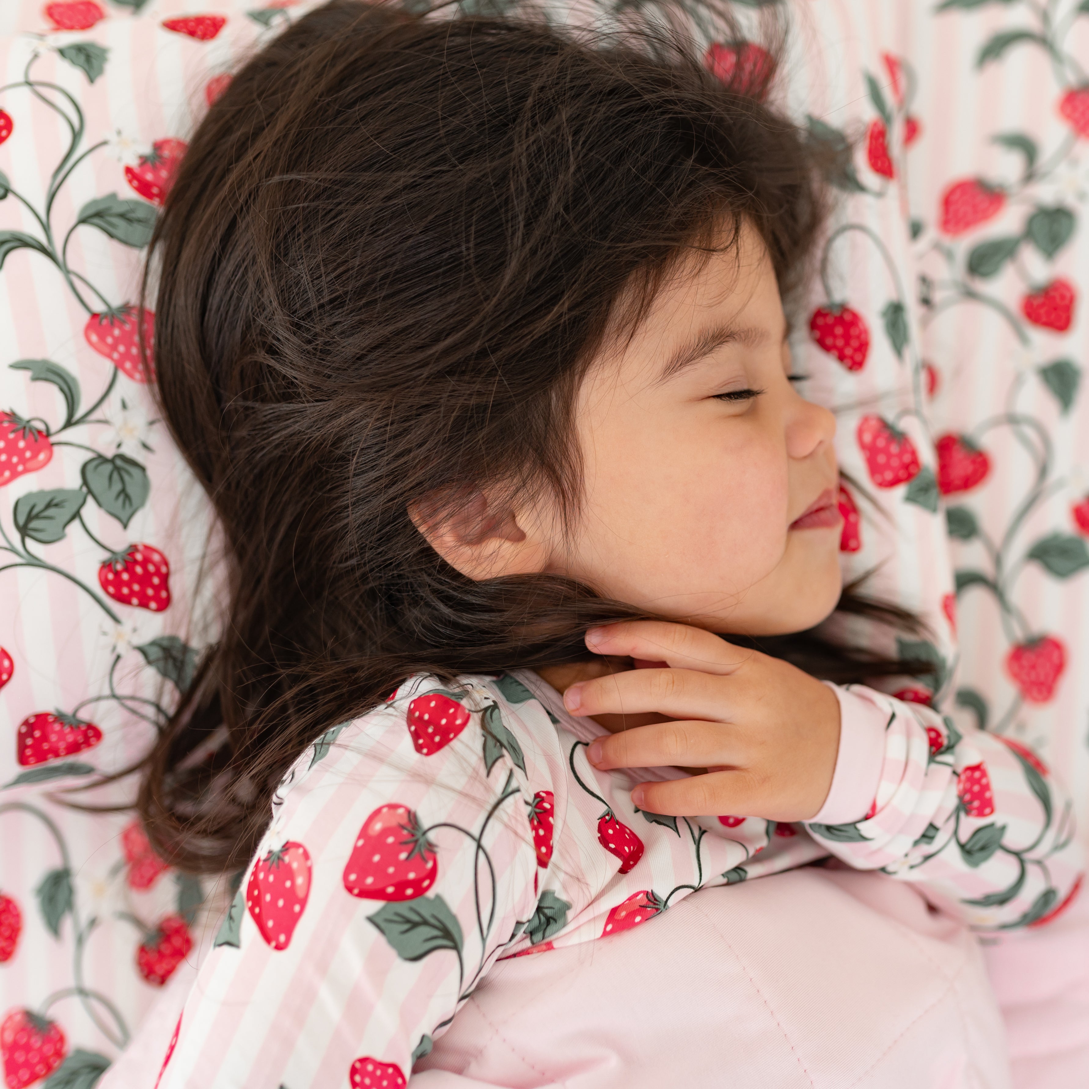 Young girl sleeping on a pillow with a Toddler Pillowcase in Strawberry Fields on top of it