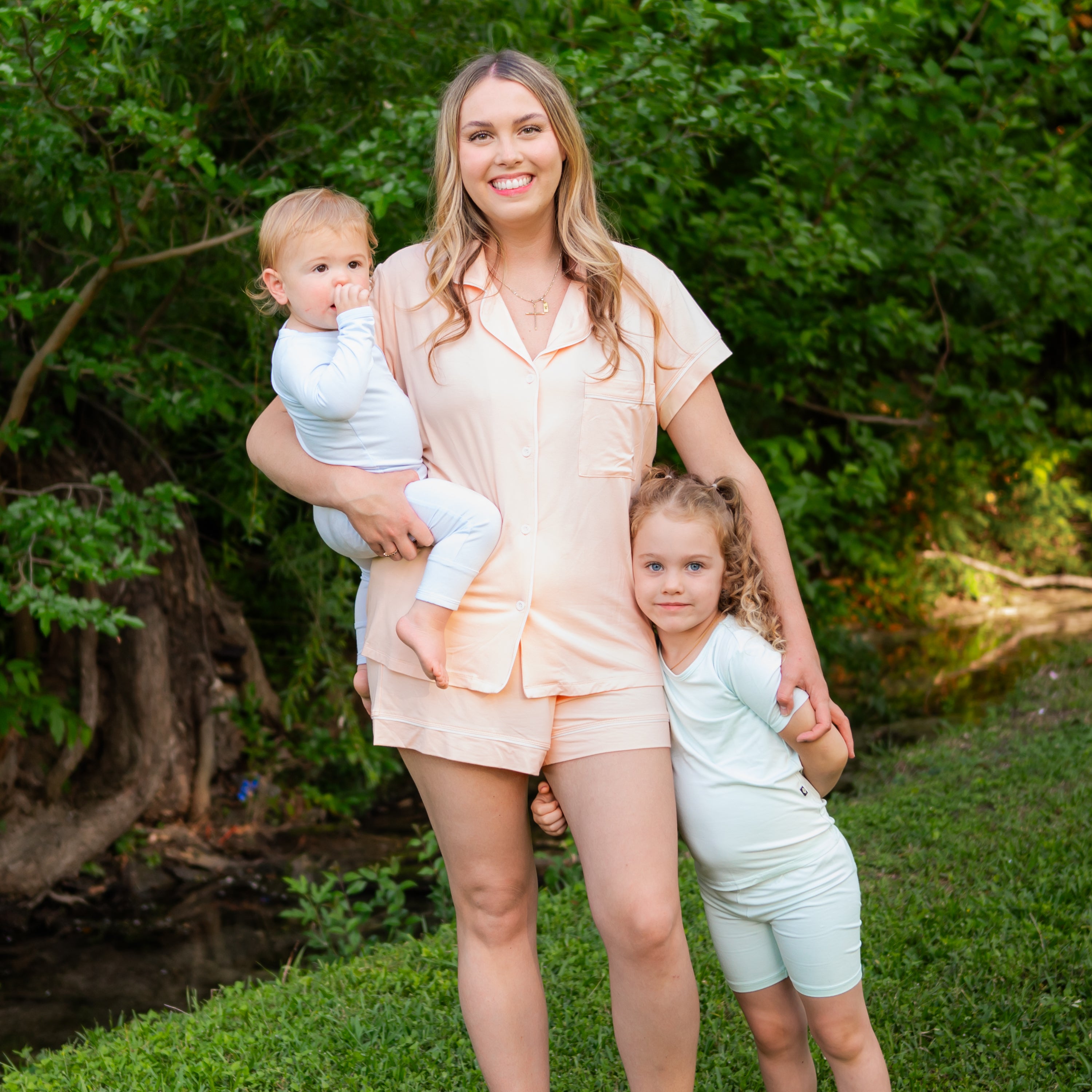 Mom wearing Canyon short sleeve pajamas with 2 children in Dew pajamas