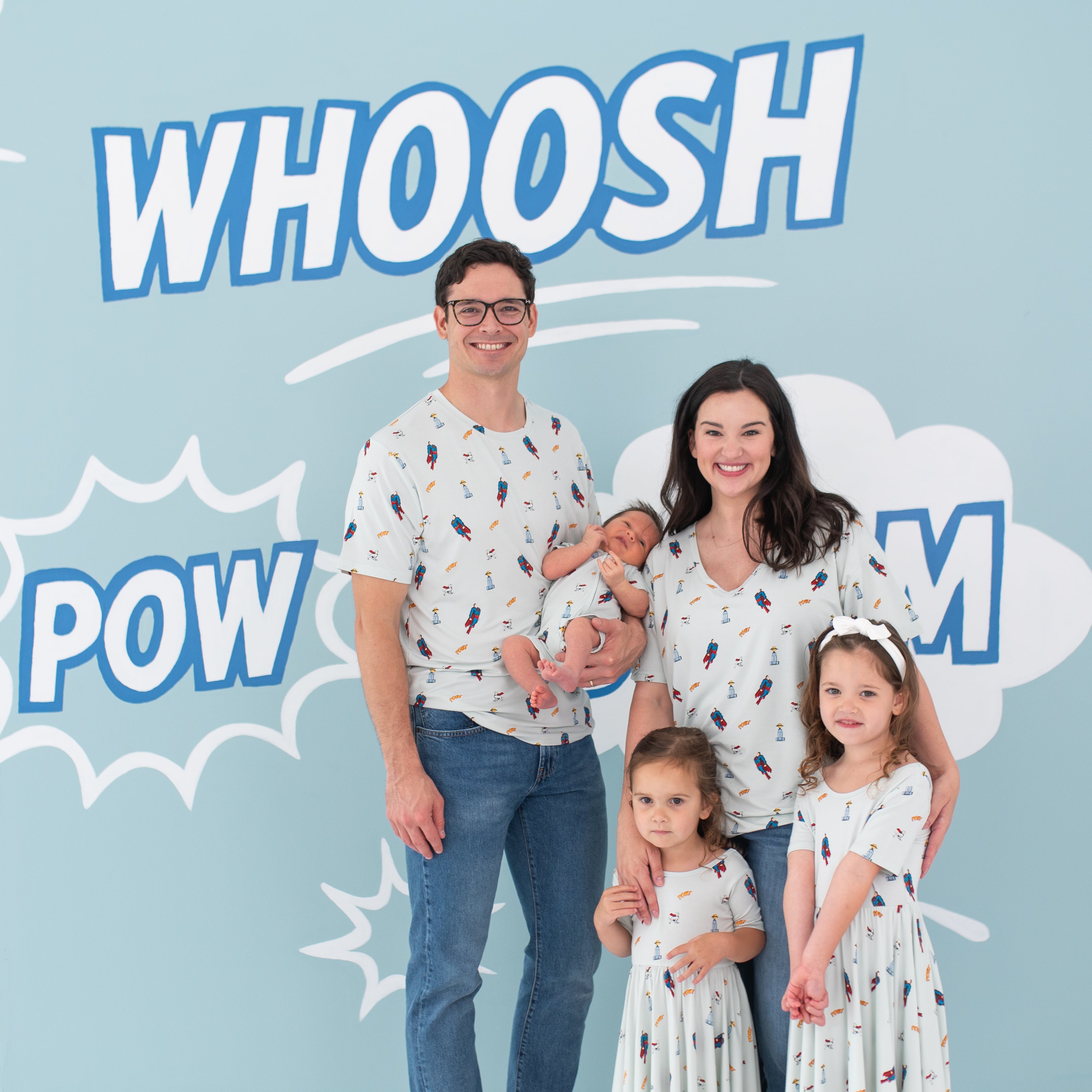 Family of five wearing various items from the Superman™ collection