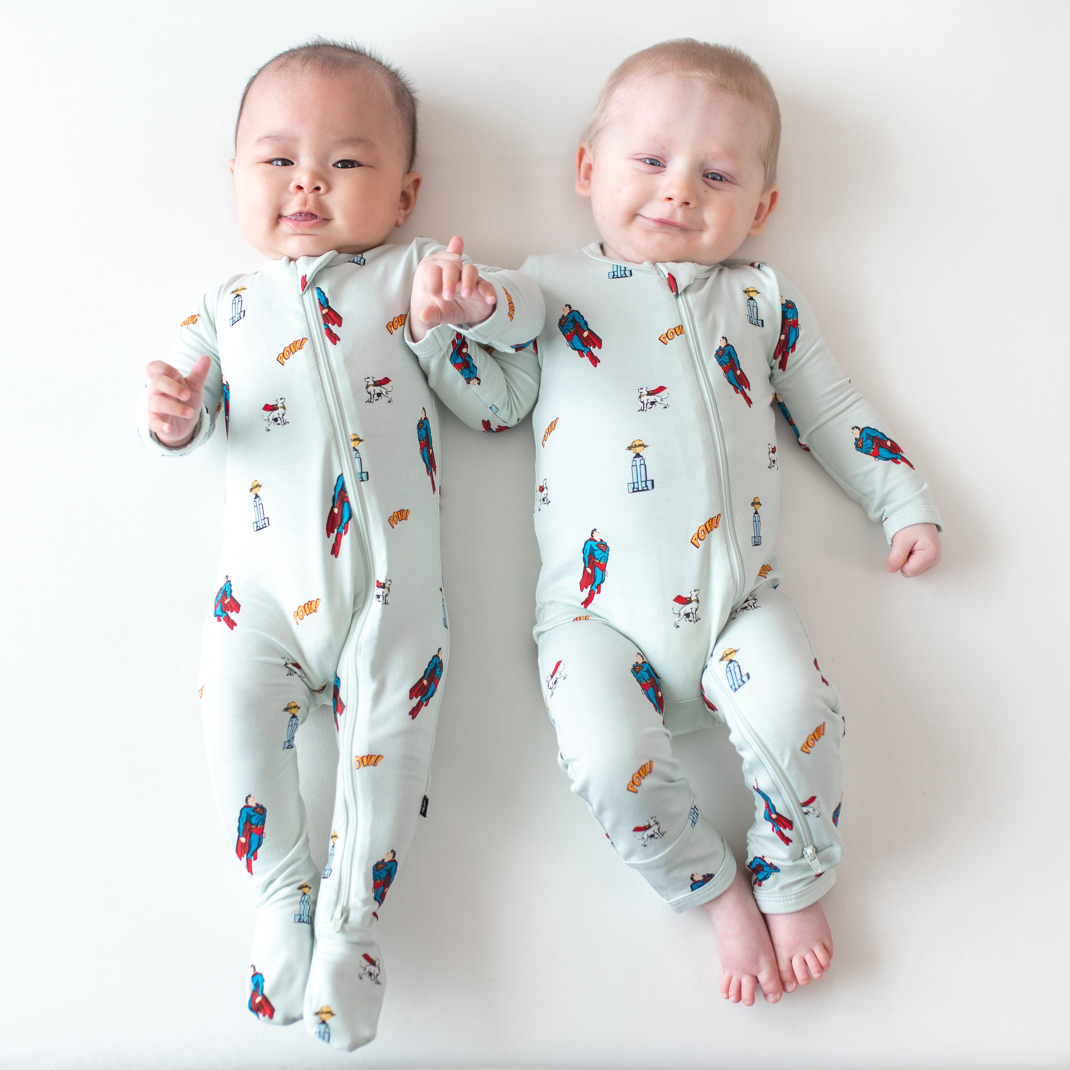 Two infants wearing Superman™ pajamas
