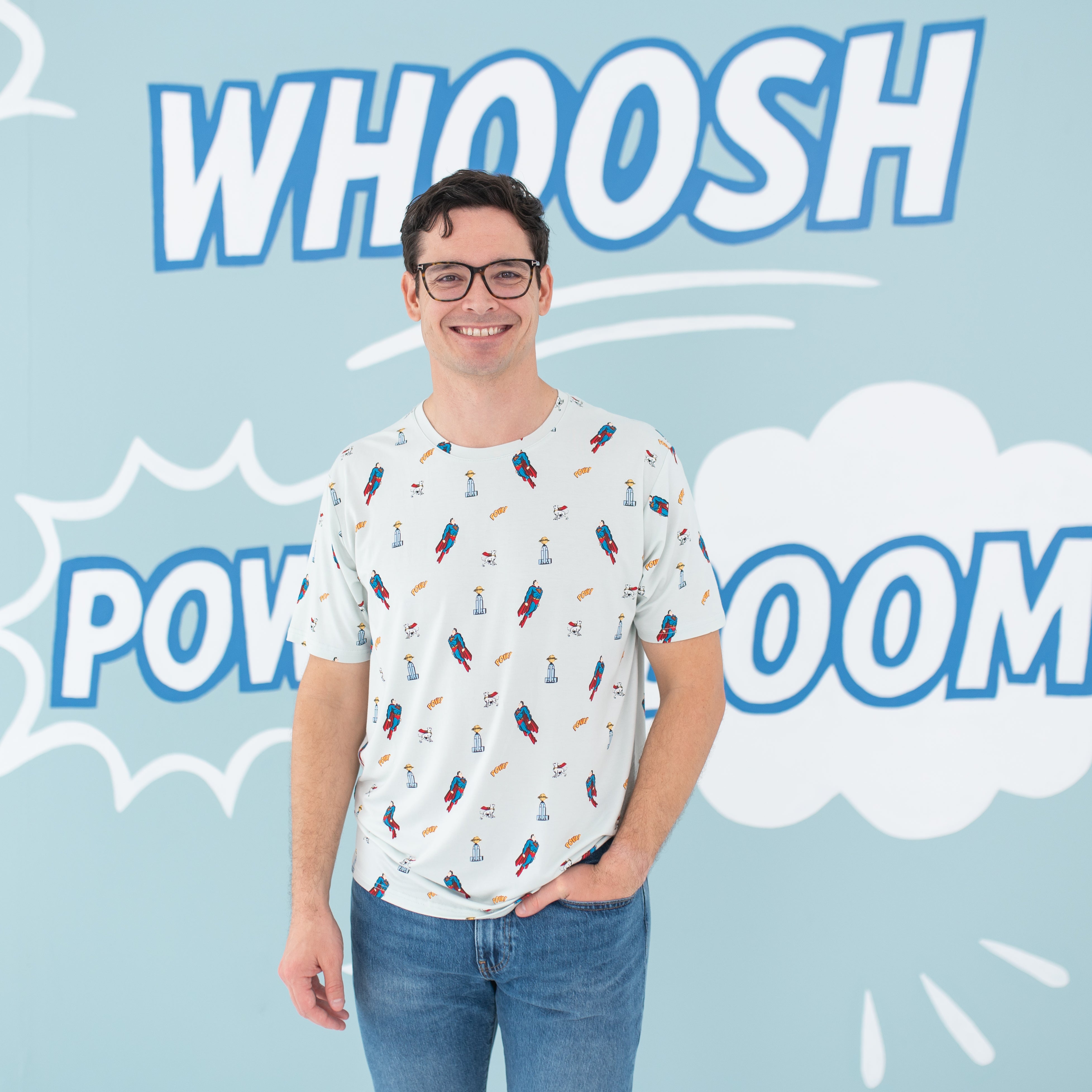 Male model standing with his hand in his jean pocket wearing the Men's Crew Neck Tee in Superman™