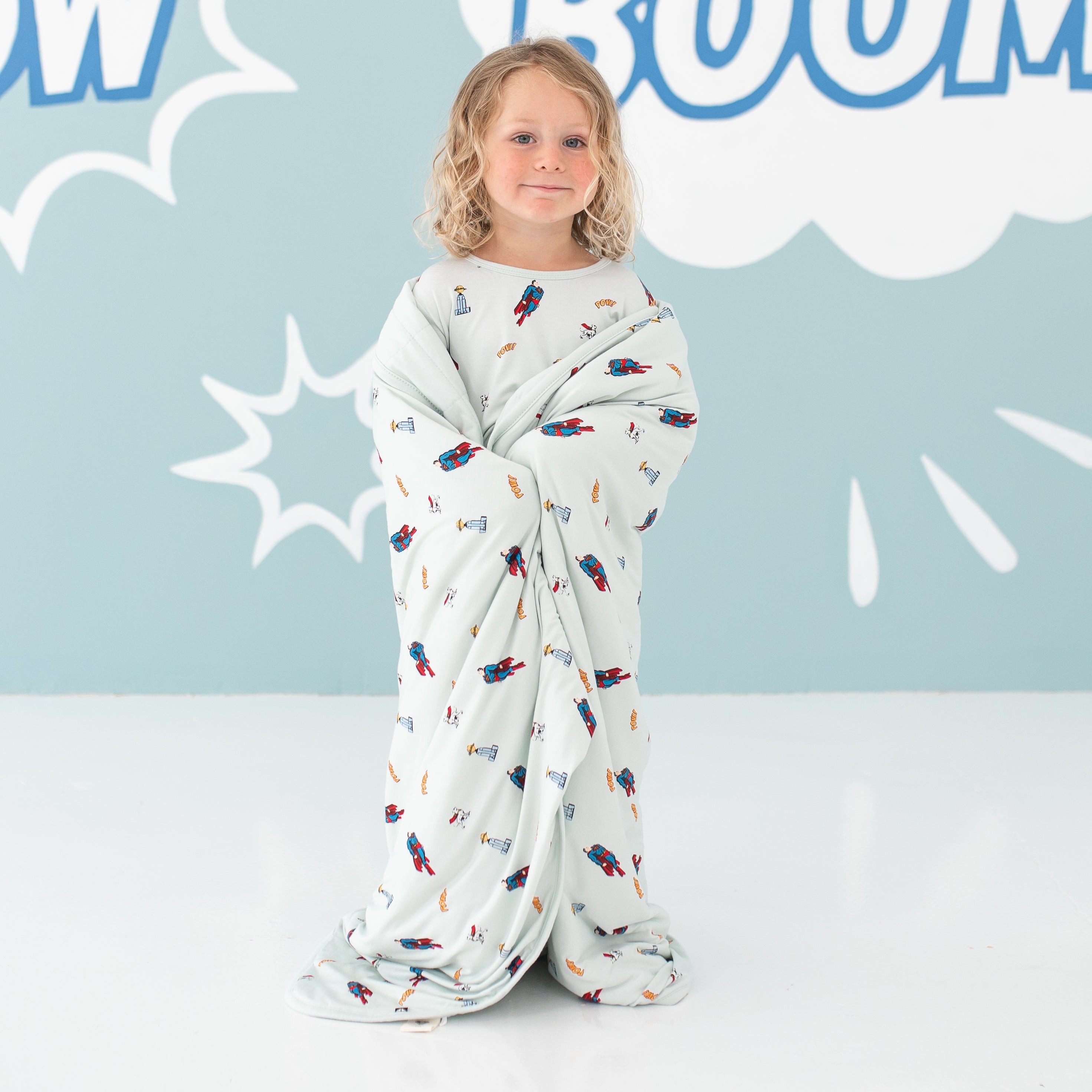 Child wrapped in bamboo Toddler Blanket in Superman™ 1.0 TOG