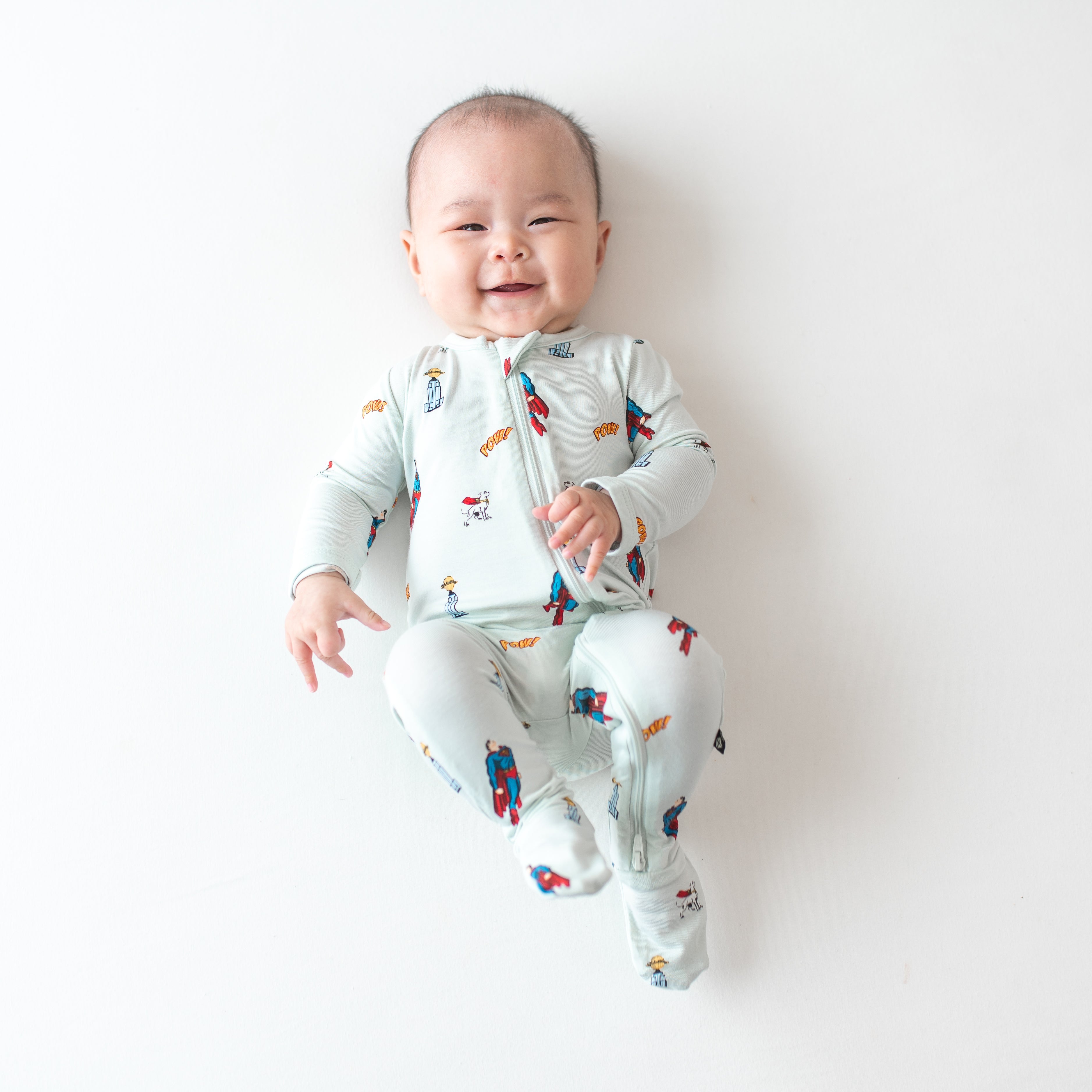 Infant wearing Zippered Footie pajamas in Superman™