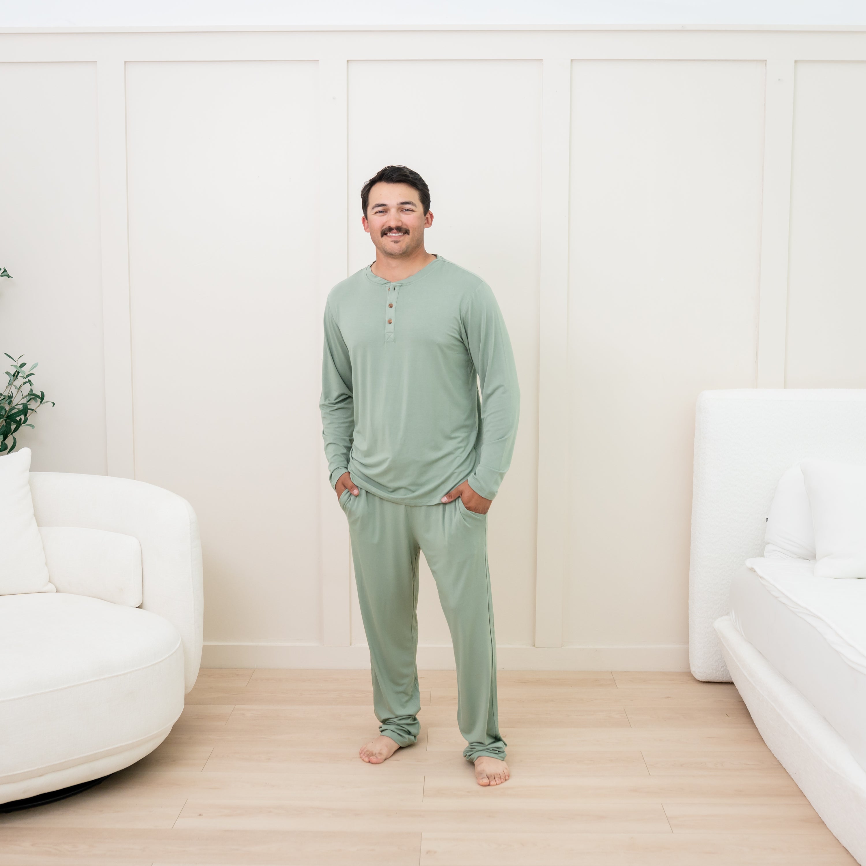 Man wearing Men's Long Sleeve Henley Top in Thyme and matching lounge pant