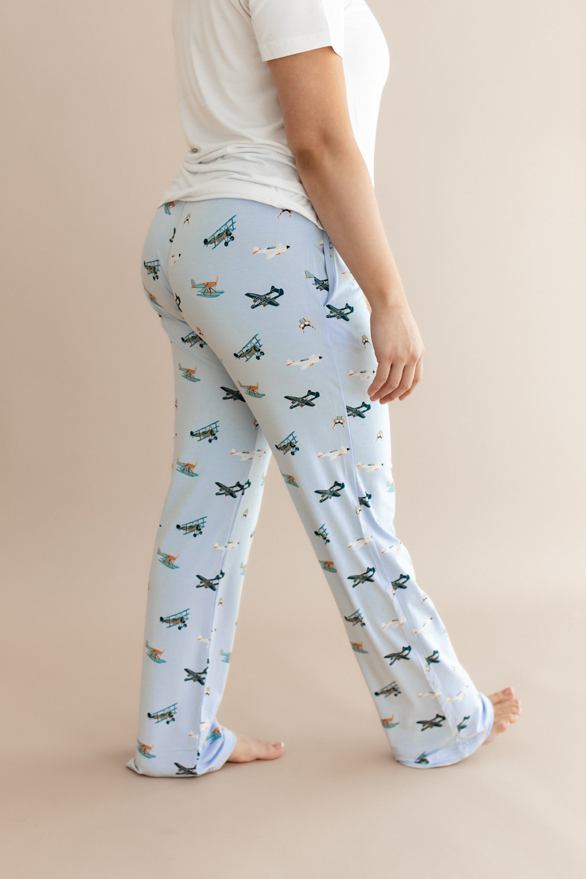 Female walking wearing the Women's Lounge Pants in Take Off showing the side and back view of the pant