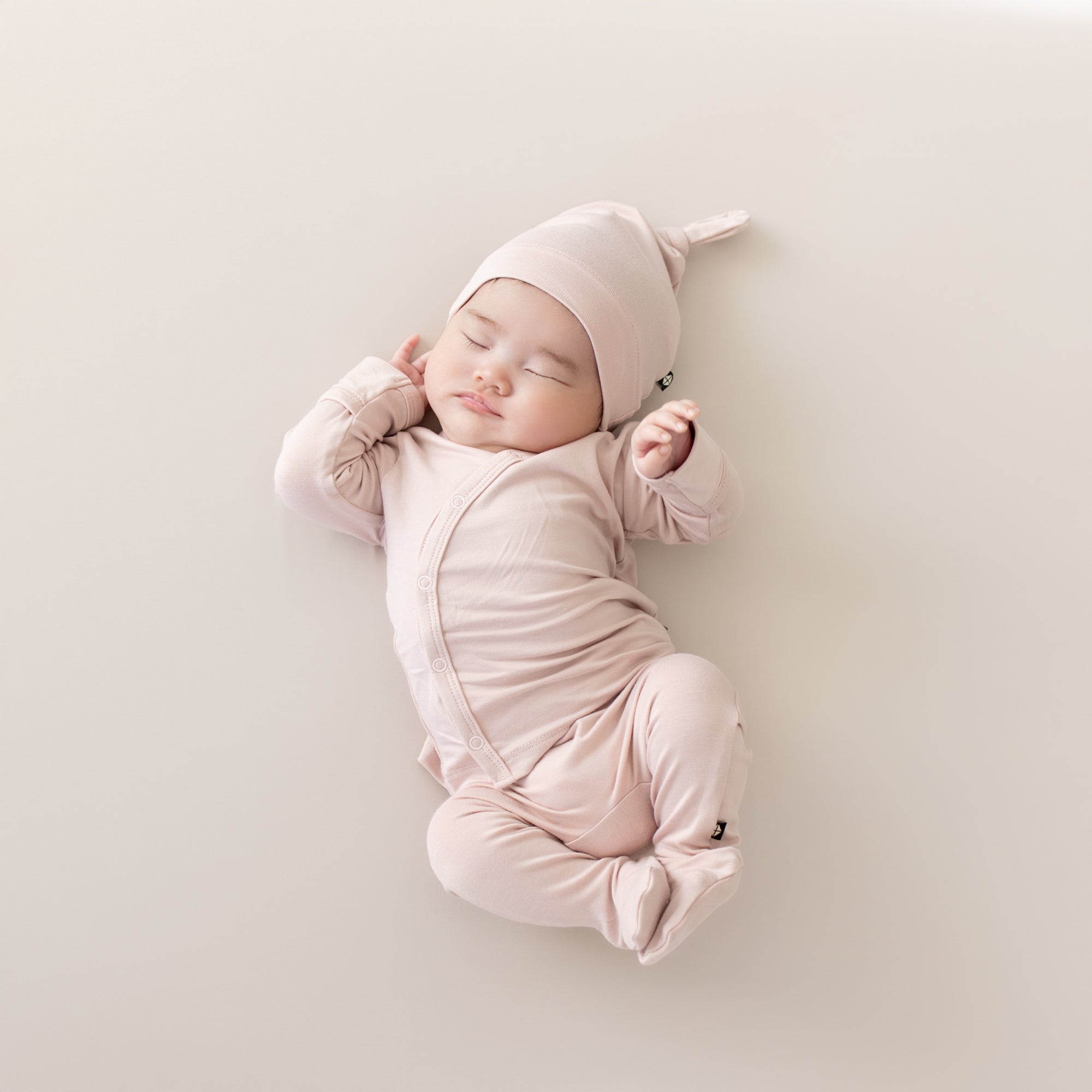 Sleeping infant in Take Me Home Set with Cap in Blush