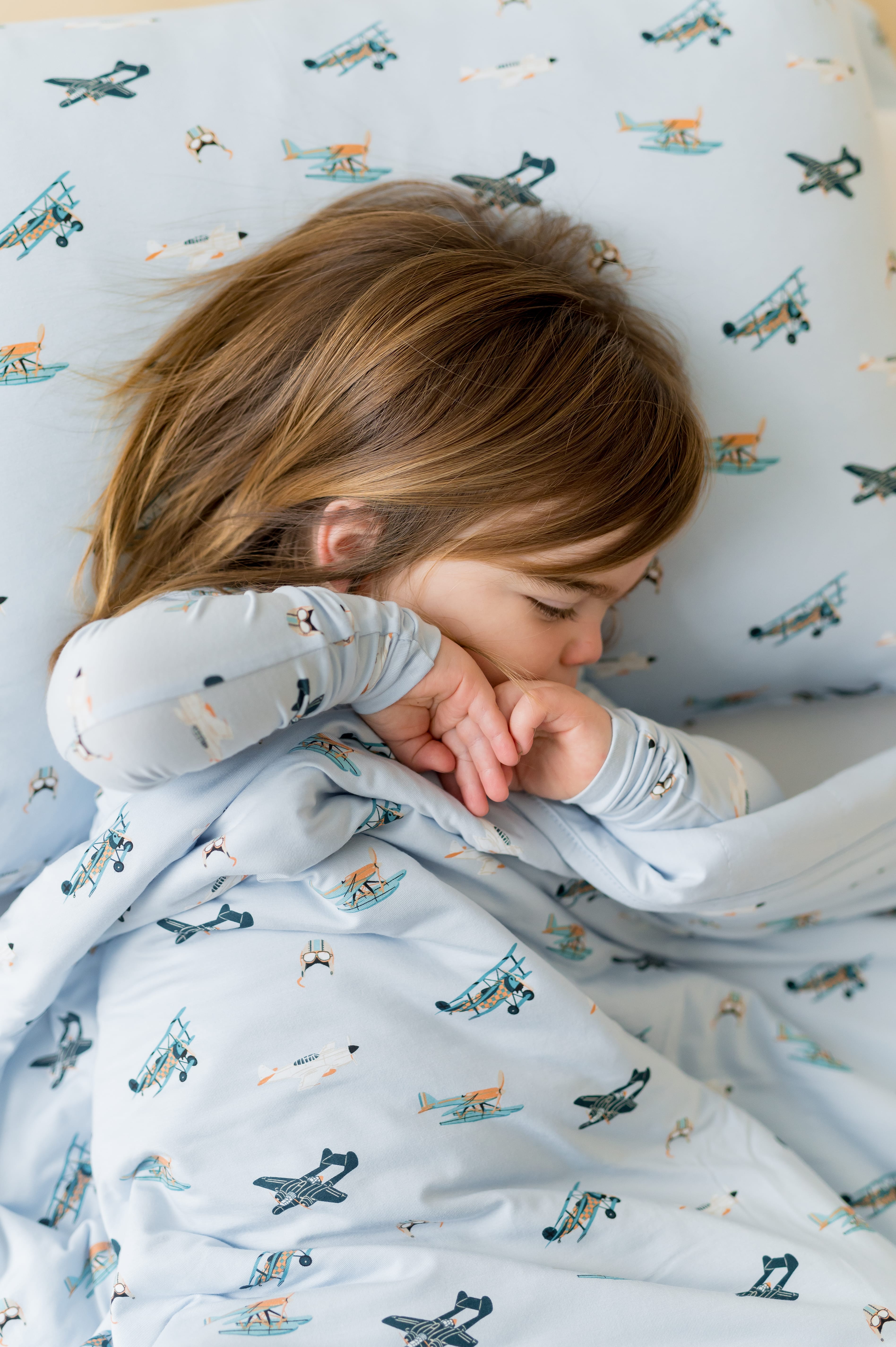 Young girl laying on a Standard Pillowcase in Take Off