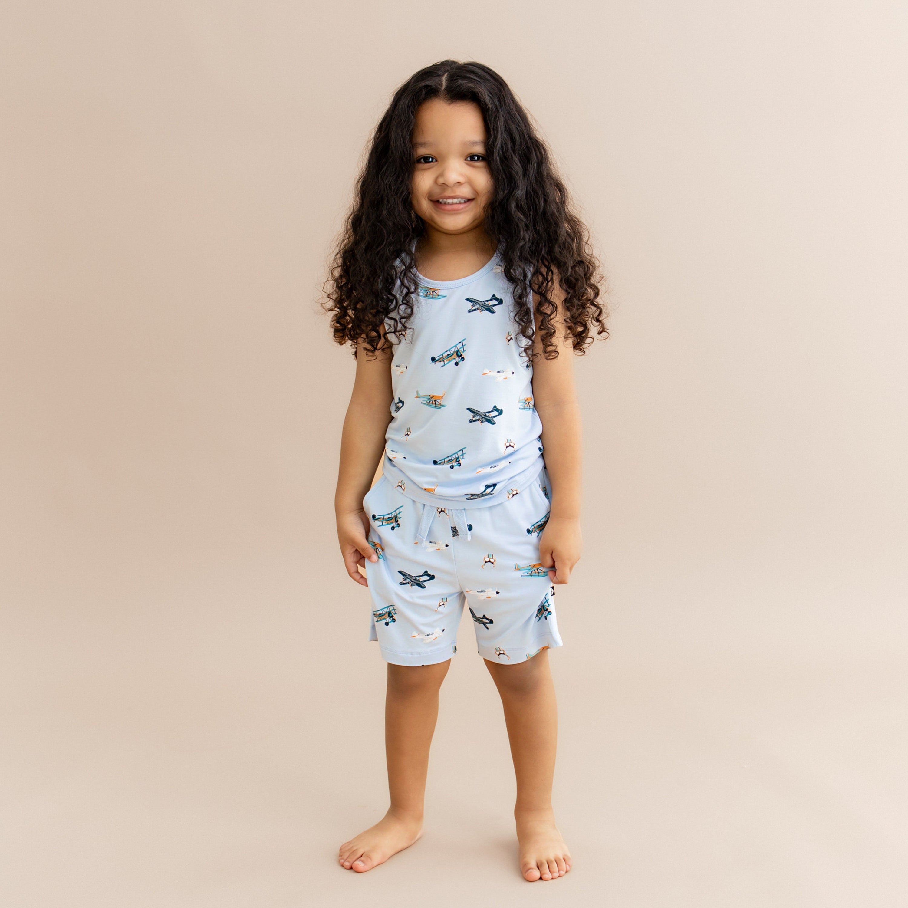 Young smiling girl wearing the Drawstring Short in Take Off with matching tank top