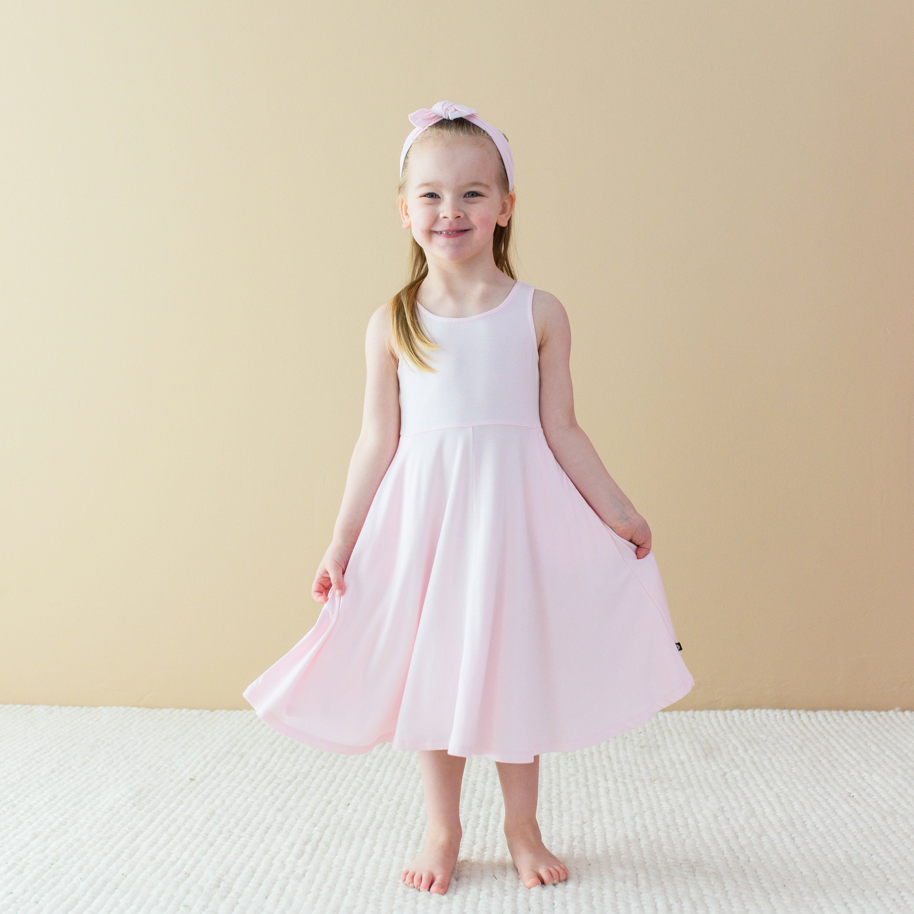 Child wearing Bamboo Tank Twirl Dress in Sakura Pink